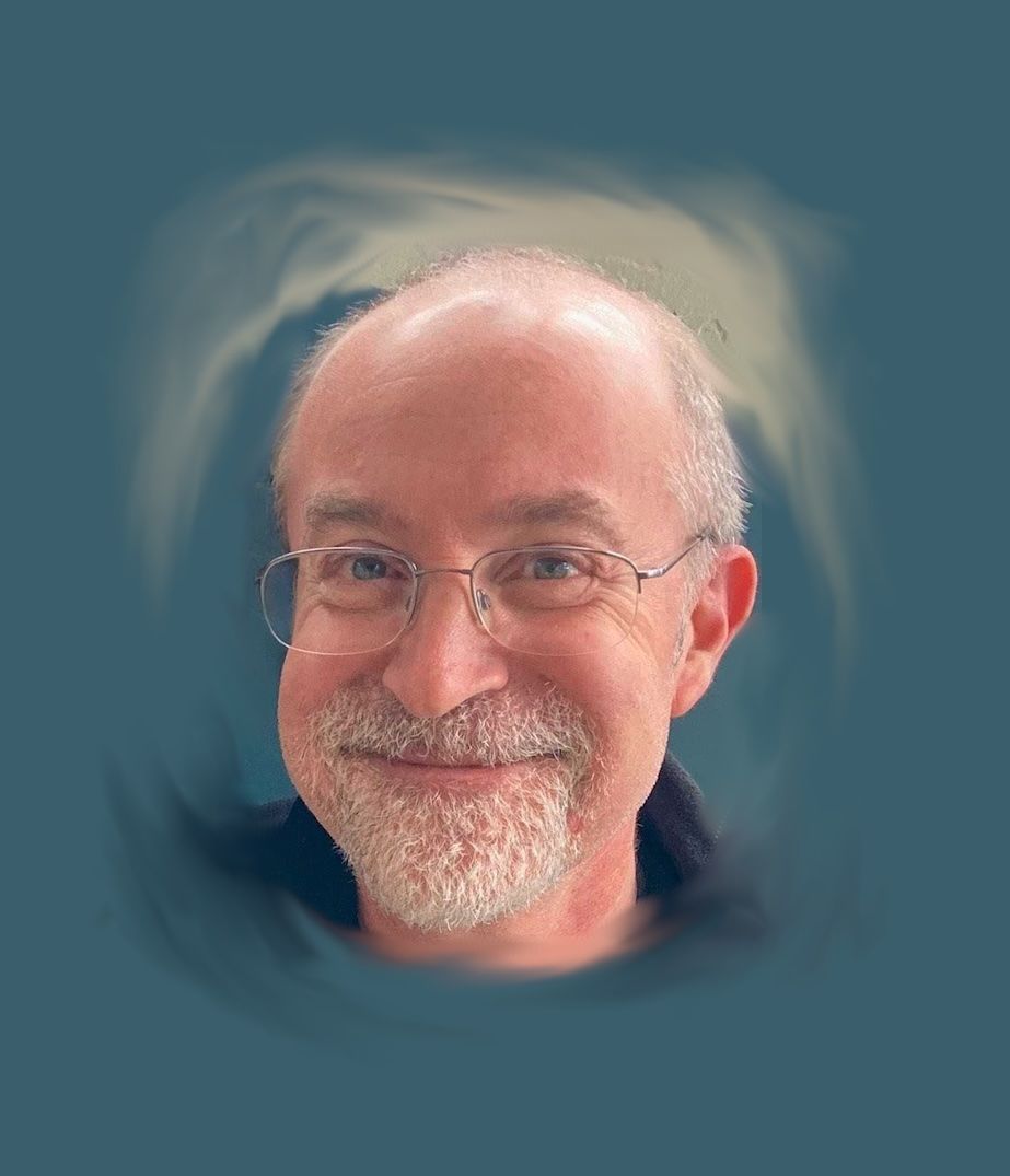 Smiling man with glasses and a gray beard