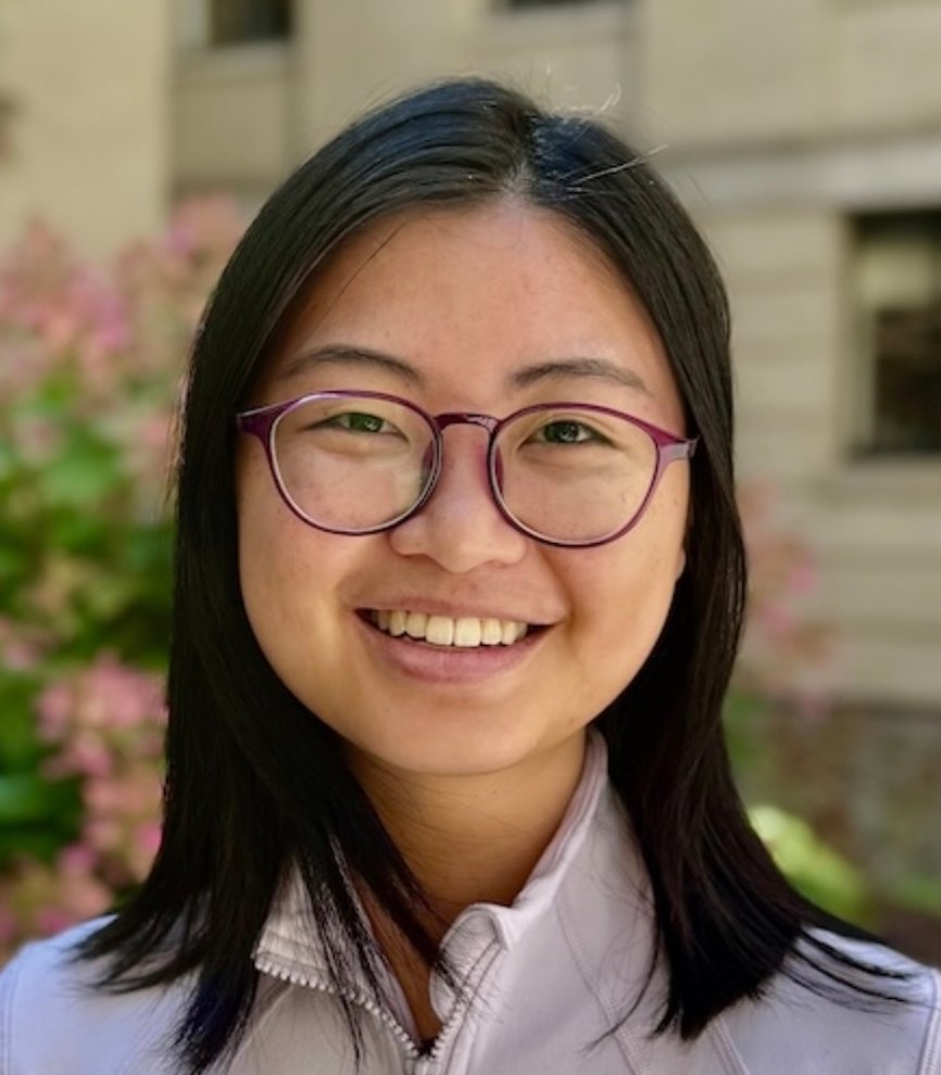 Woman with glasses smiling outdoors