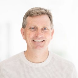 Smiling man wearing a light knit sweater