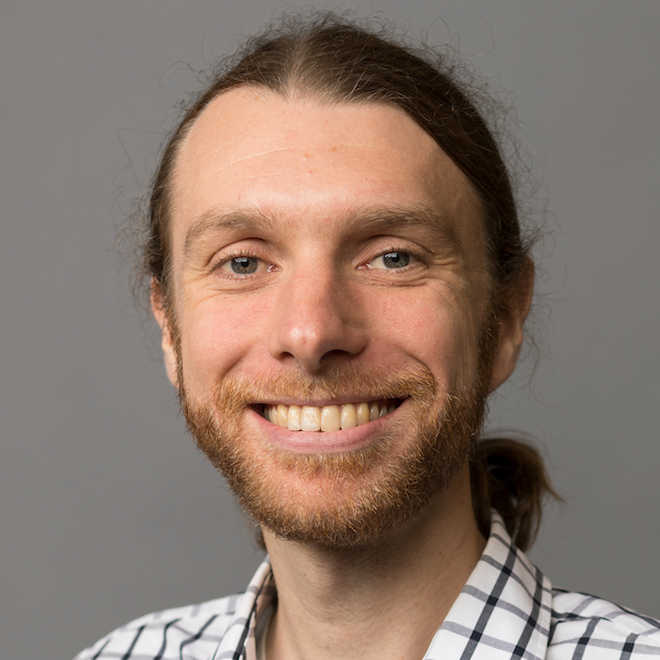 Smiling man with a beard and long hair