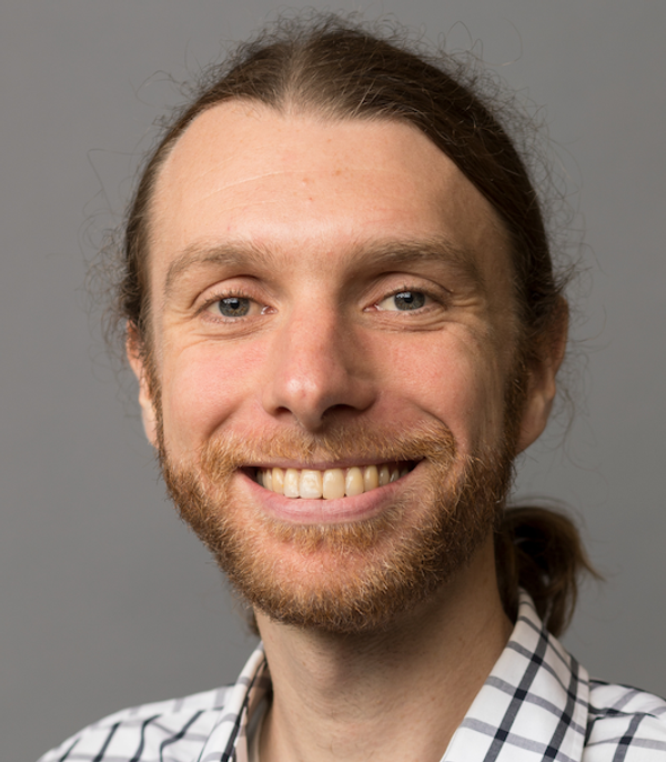 Smiling man with a beard and long hair