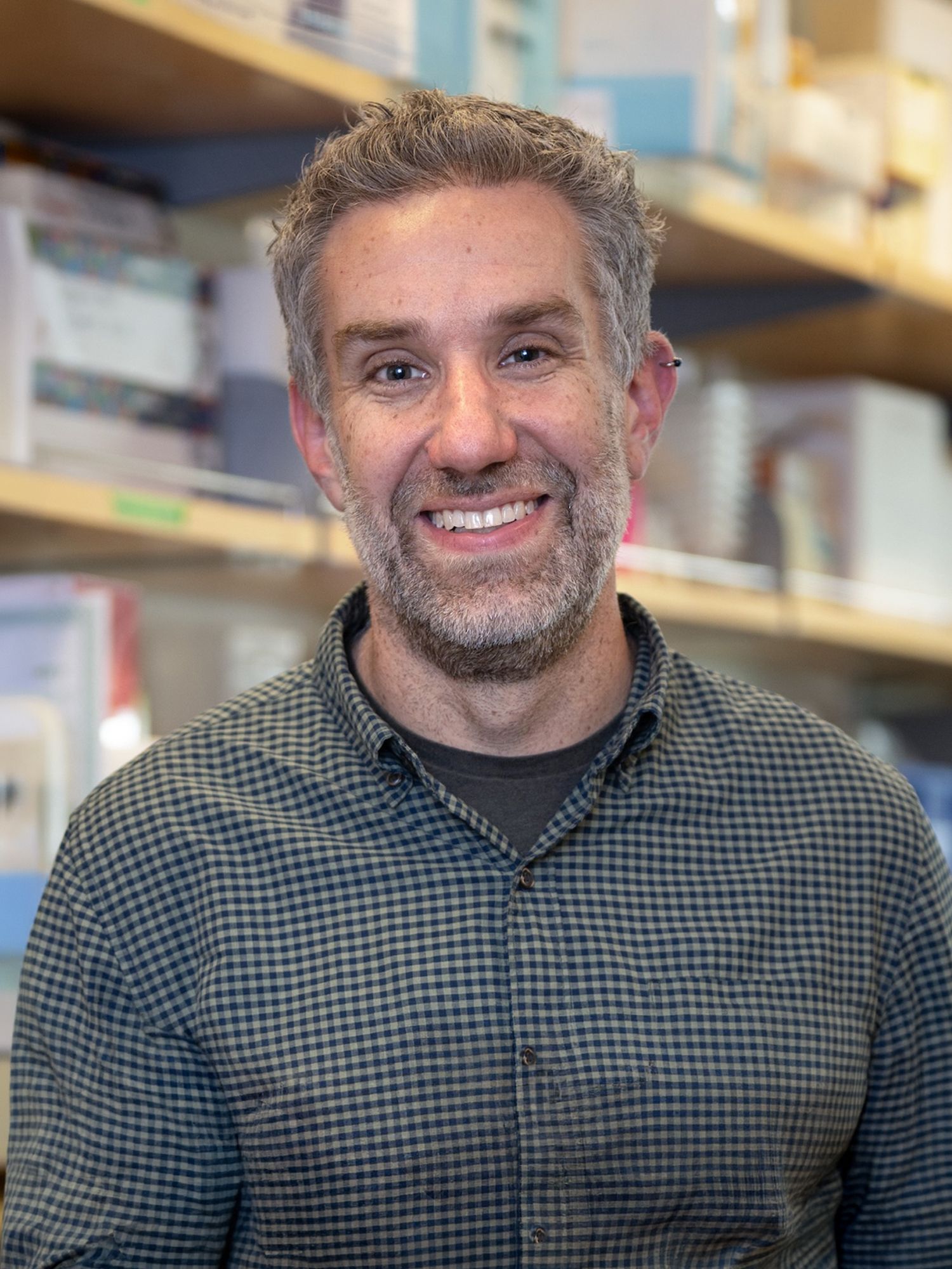 Smiling man with short gray hair and beard