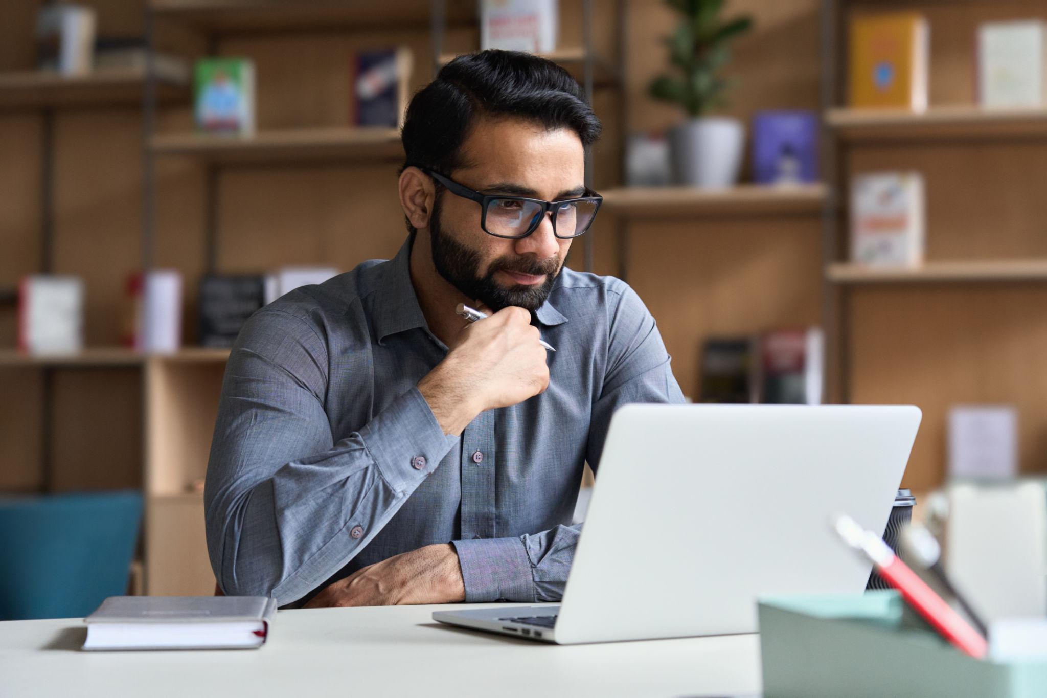 Entrepreneur analyzing business ideas and planning strategies on a laptop.