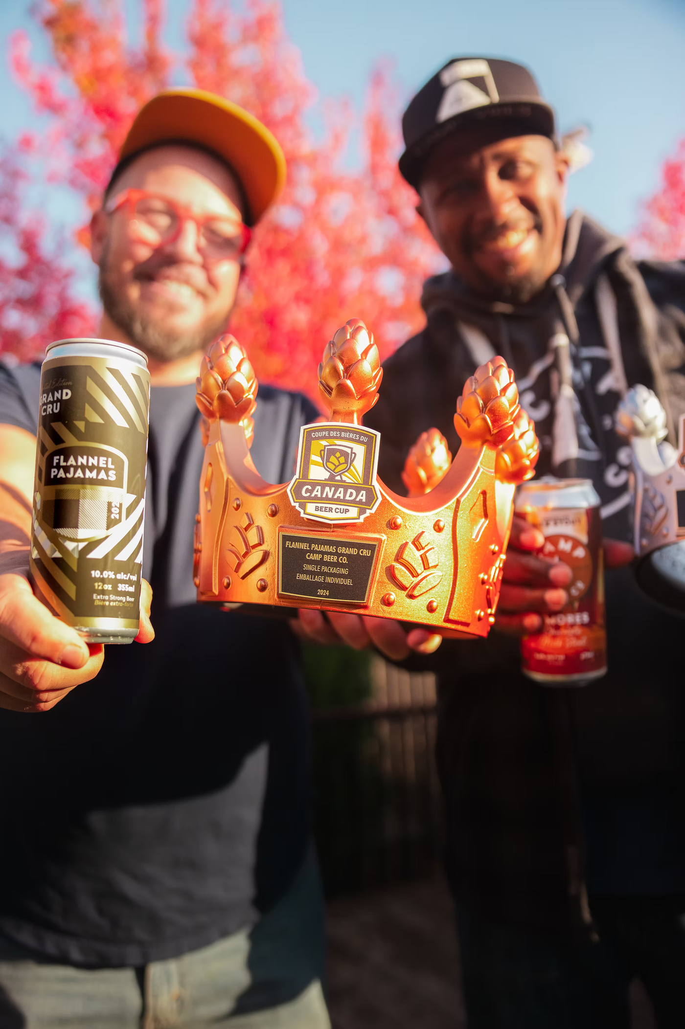 Camp Beer Co. brewers holding the Canada Beer Cup crown and Flannel Pajamas cans