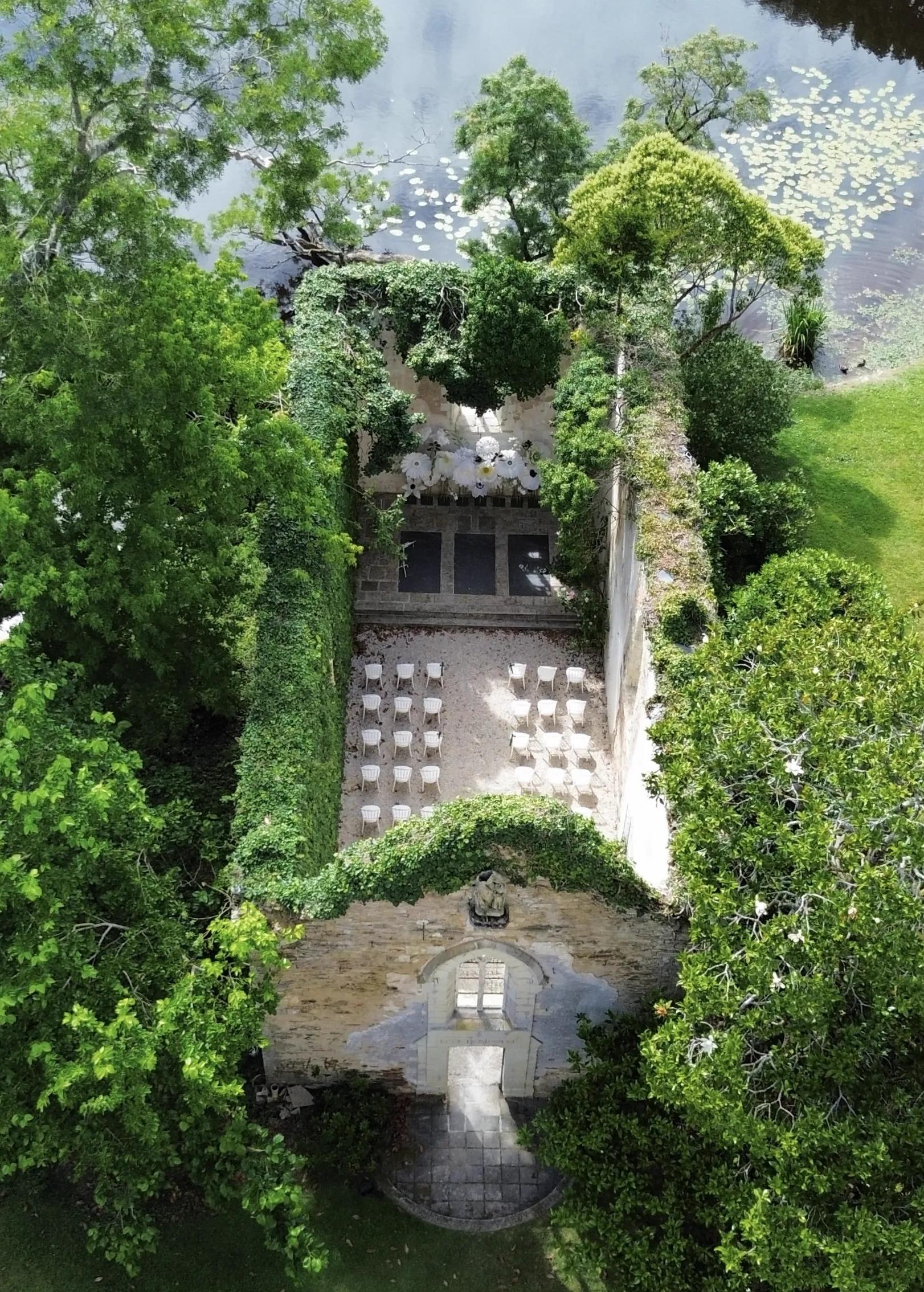 Aerial view of the open-roof chapel, set for a ceremony by the lake