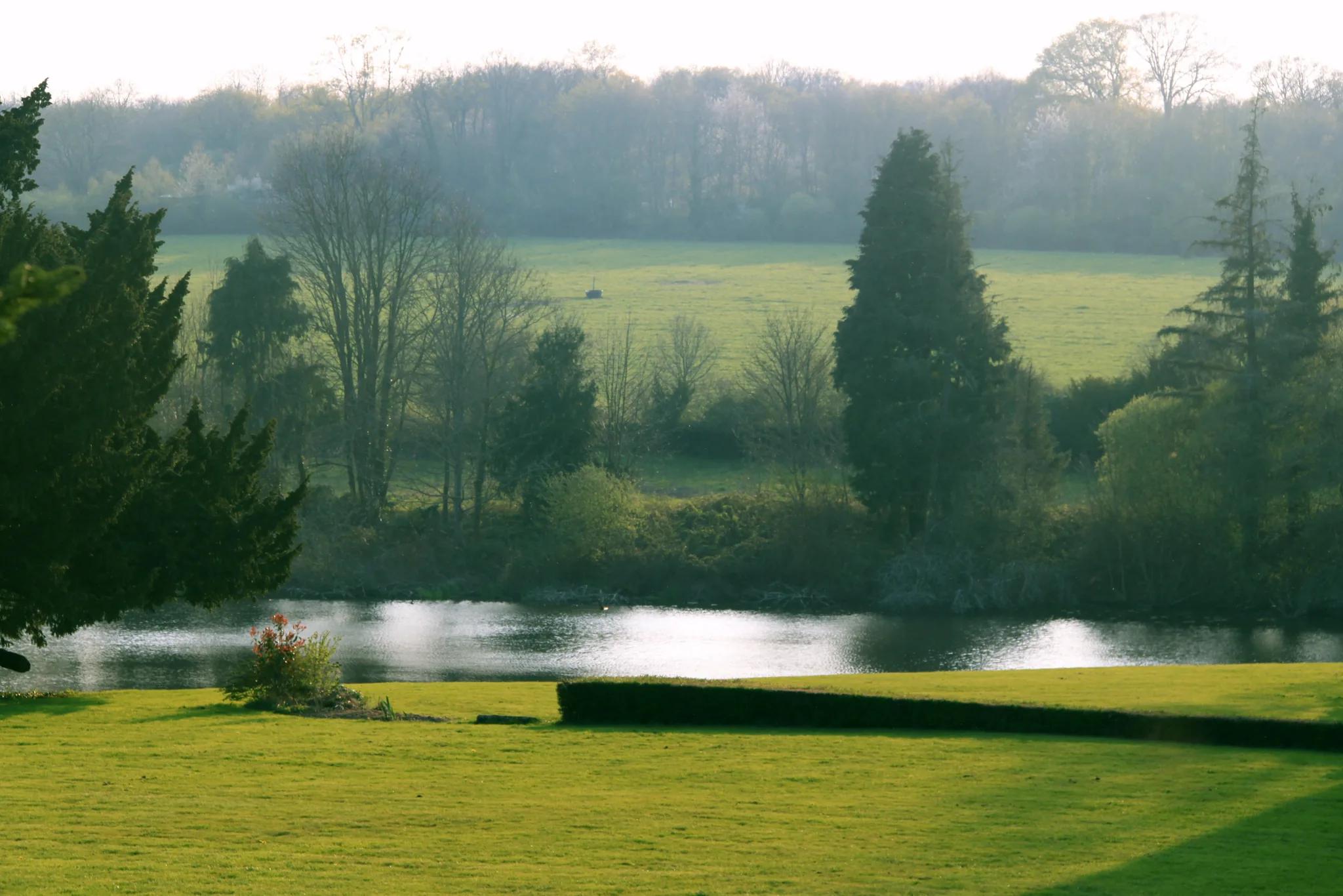 The lawn, the lake and the countryside at first light