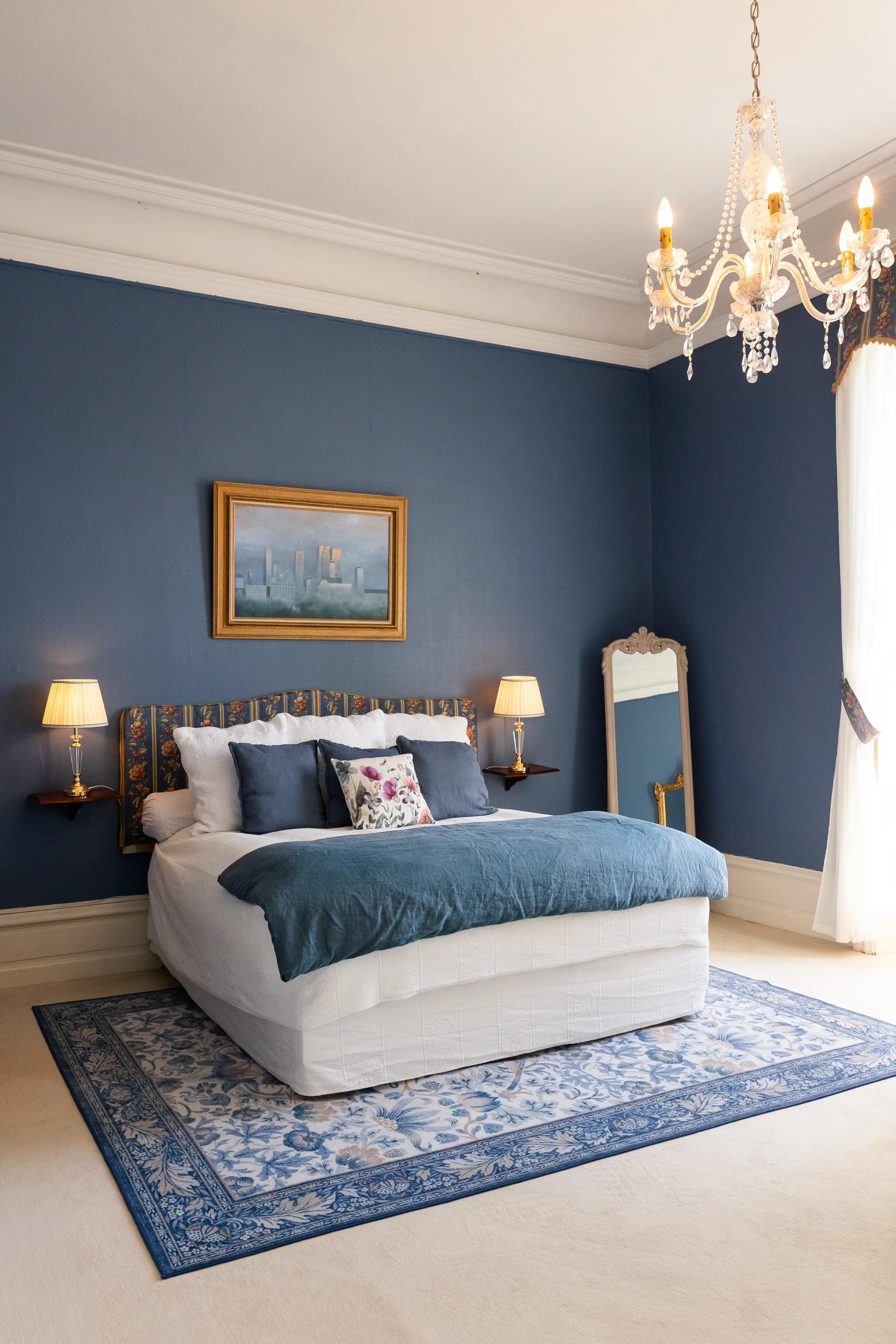 The blue bedroom and its chandelier, seen from the doorway