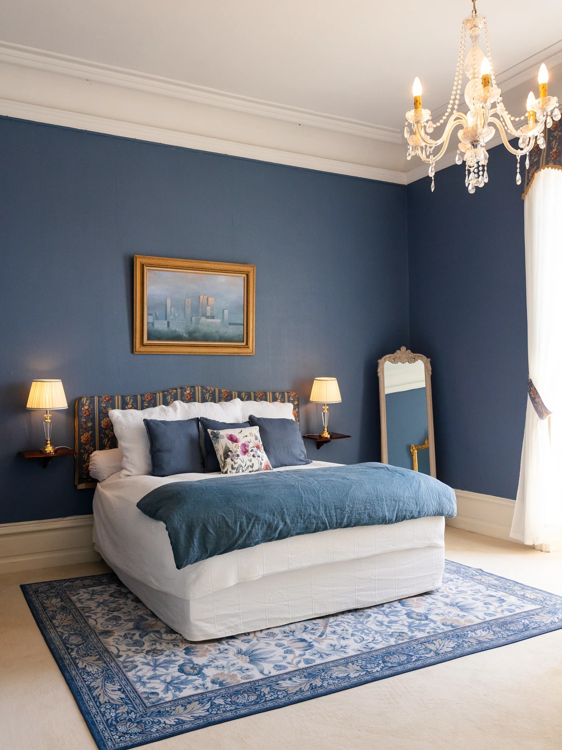 The Count and Countess room, its blue walls and crystal chandelier