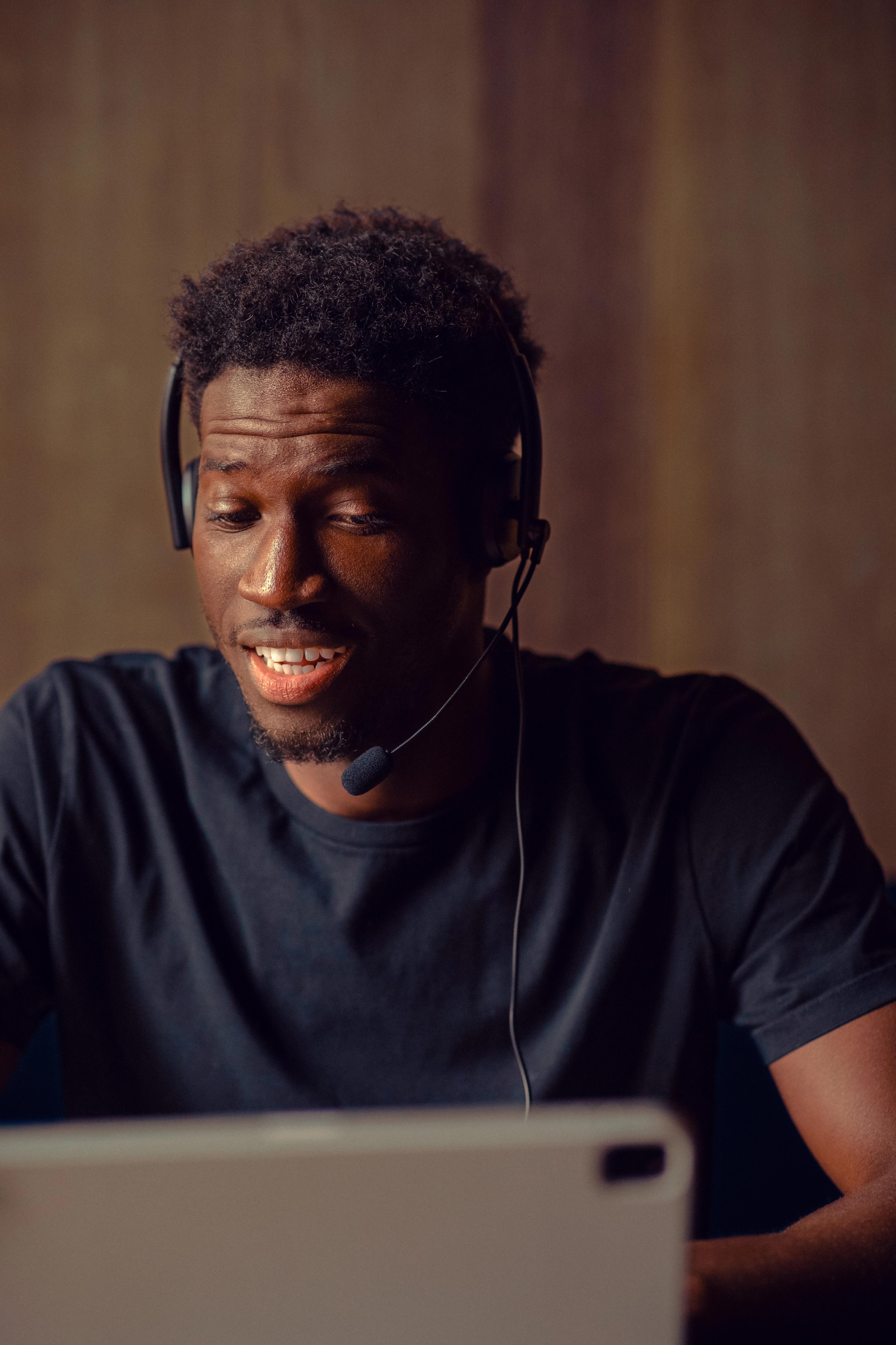 Man in a headset looking down at a tablet