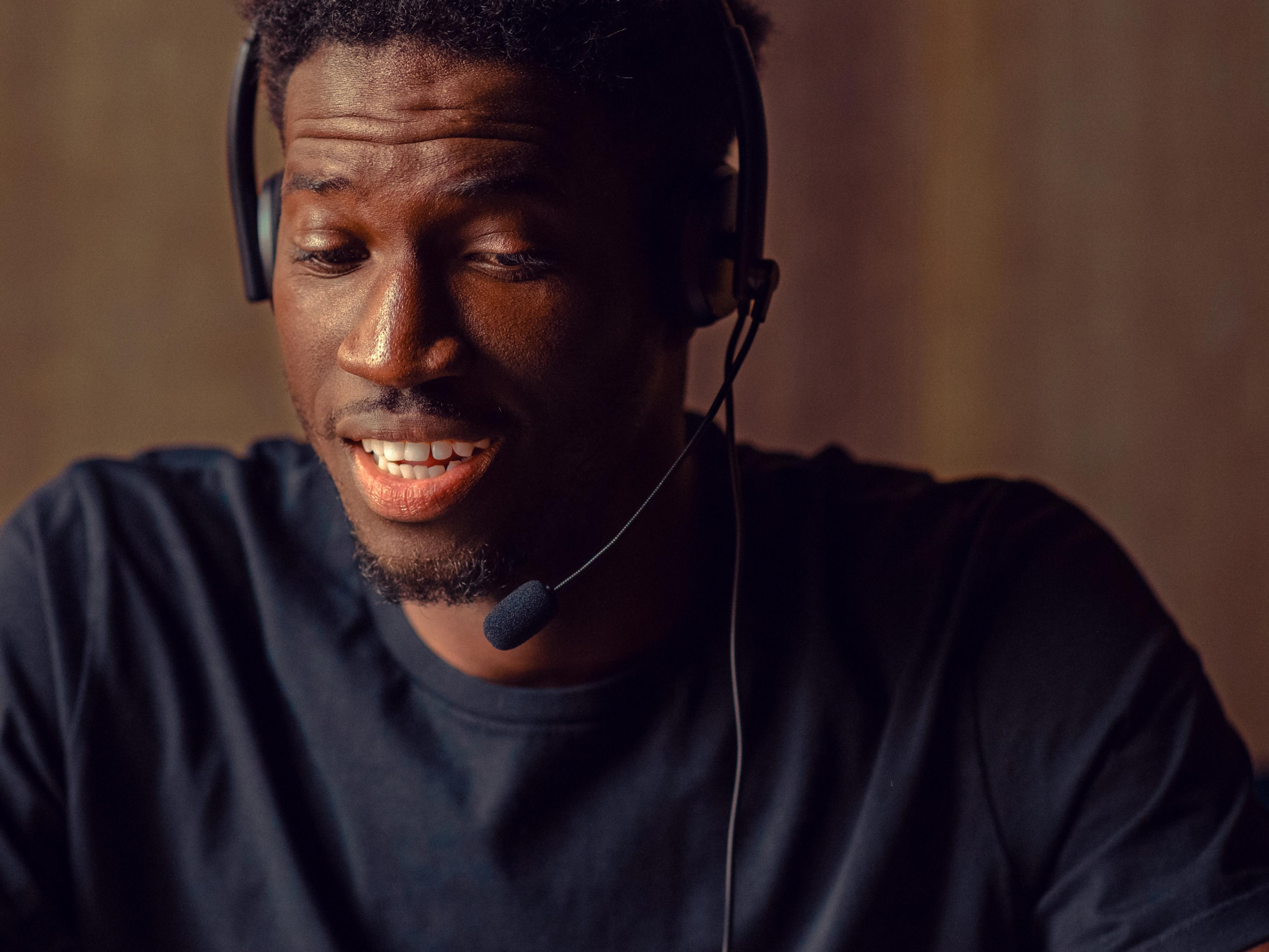 Man in a headset looking down at a tablet