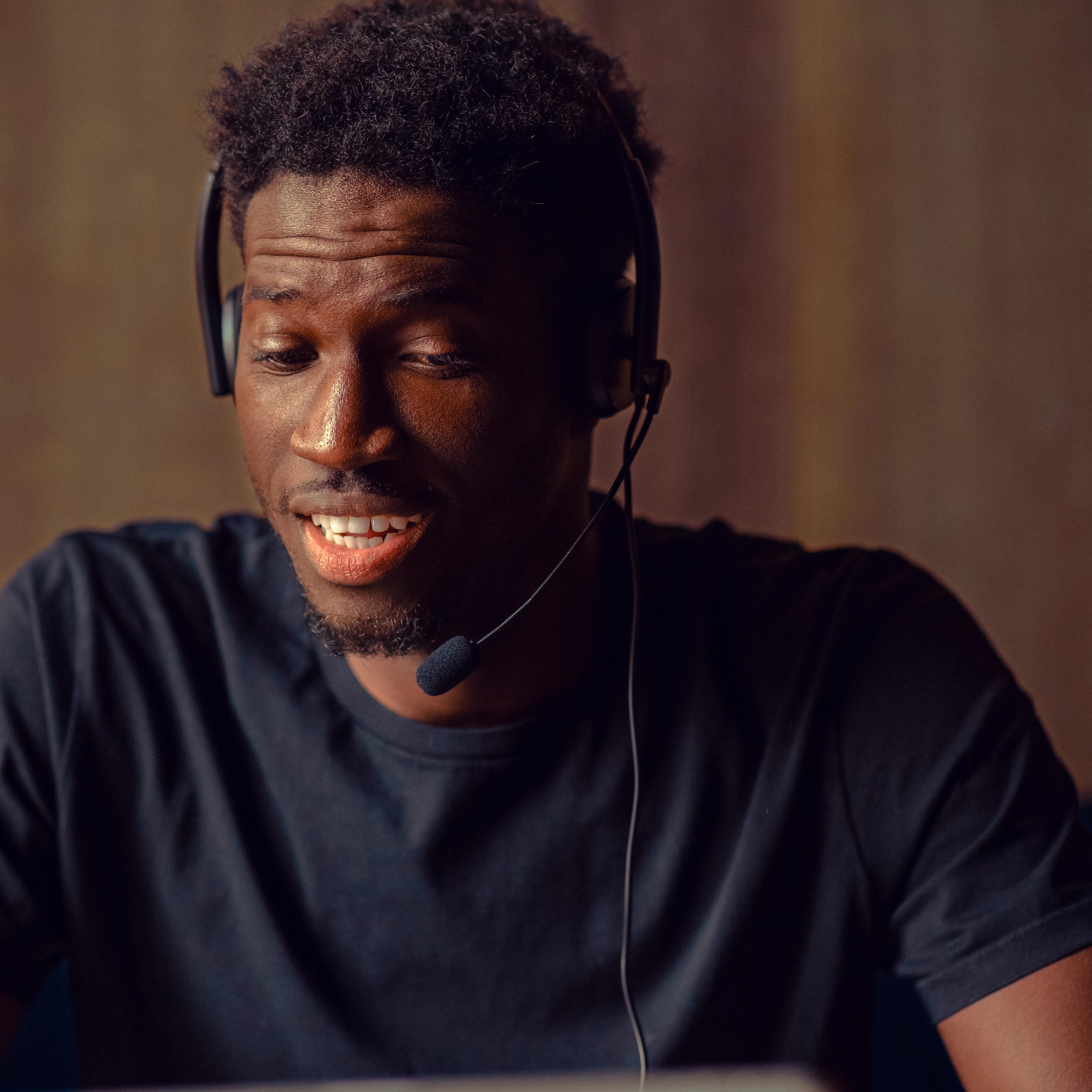 Man in a headset looking down at a tablet