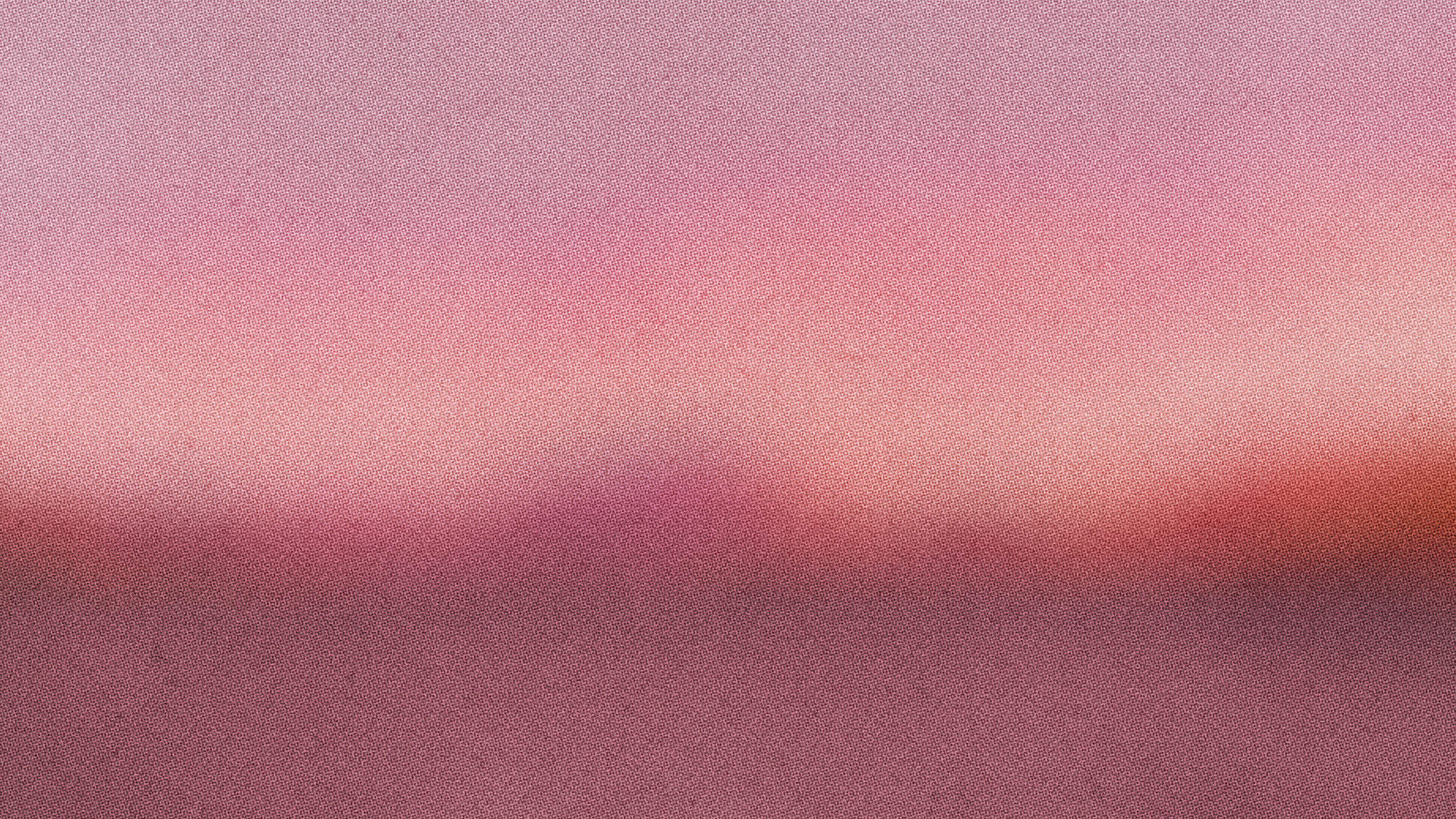 Blurred pink and mauve gradient with a soft glow