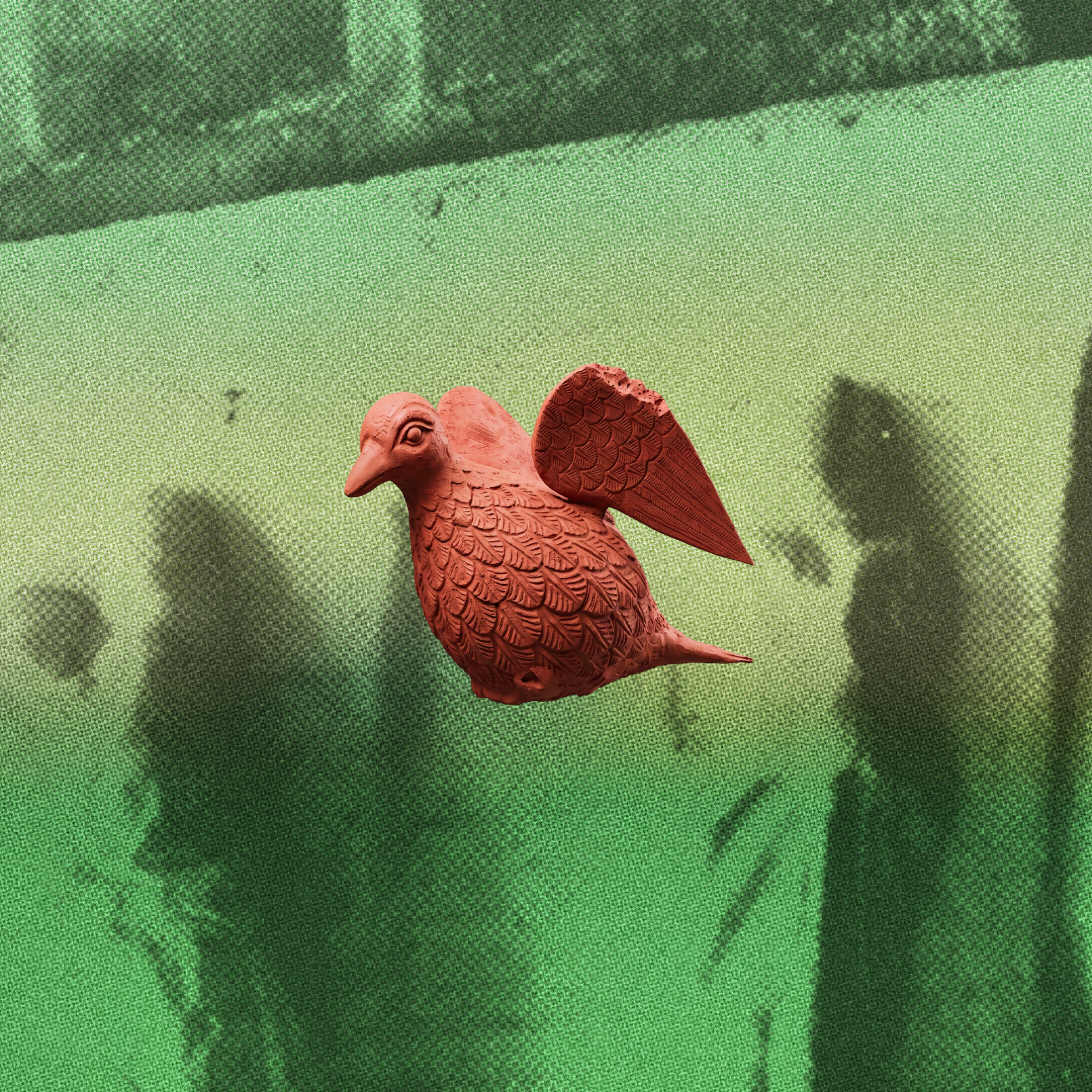 Clay bird over a green background