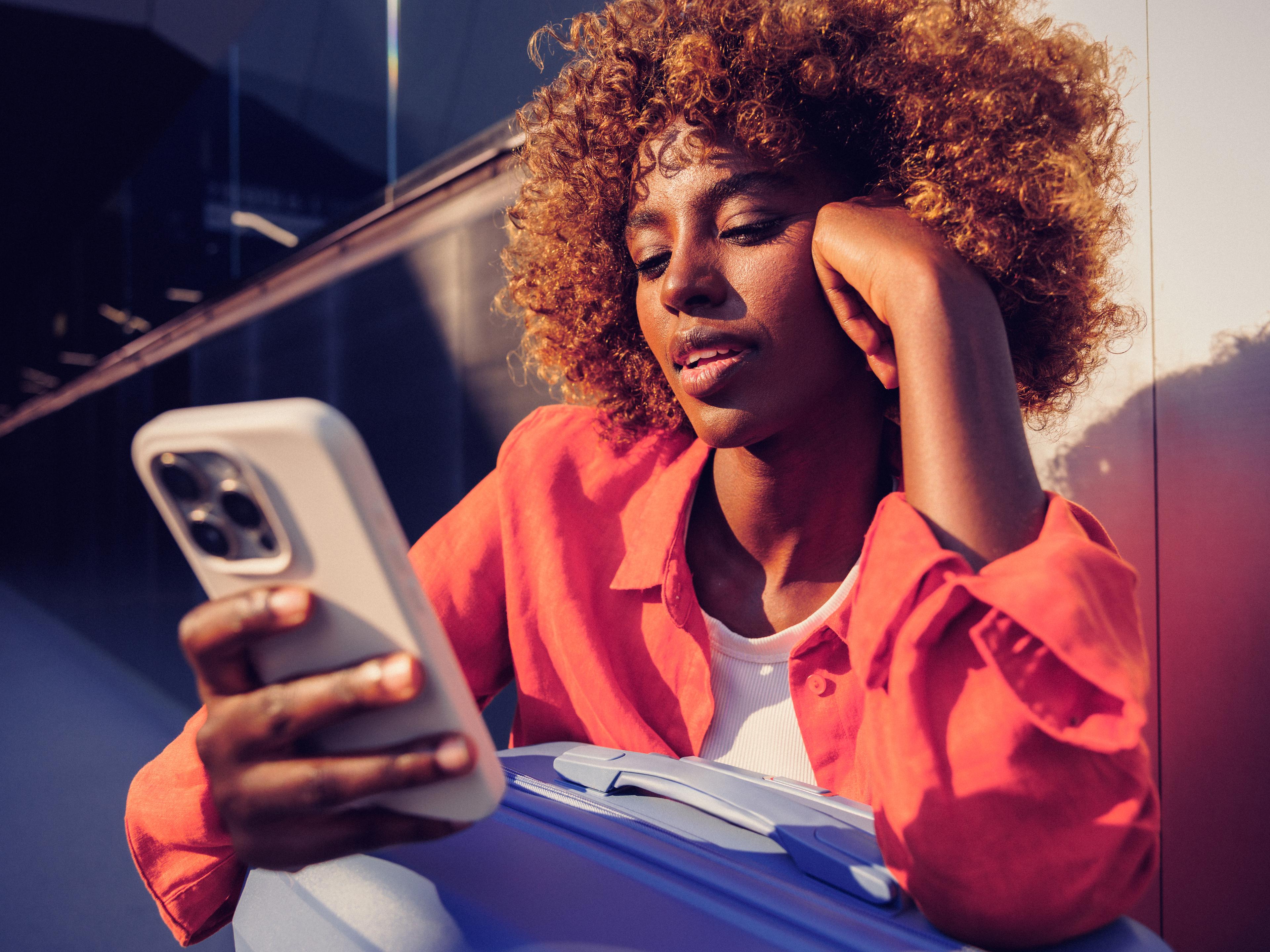 Woman resting her head on her hand as she reads her phone