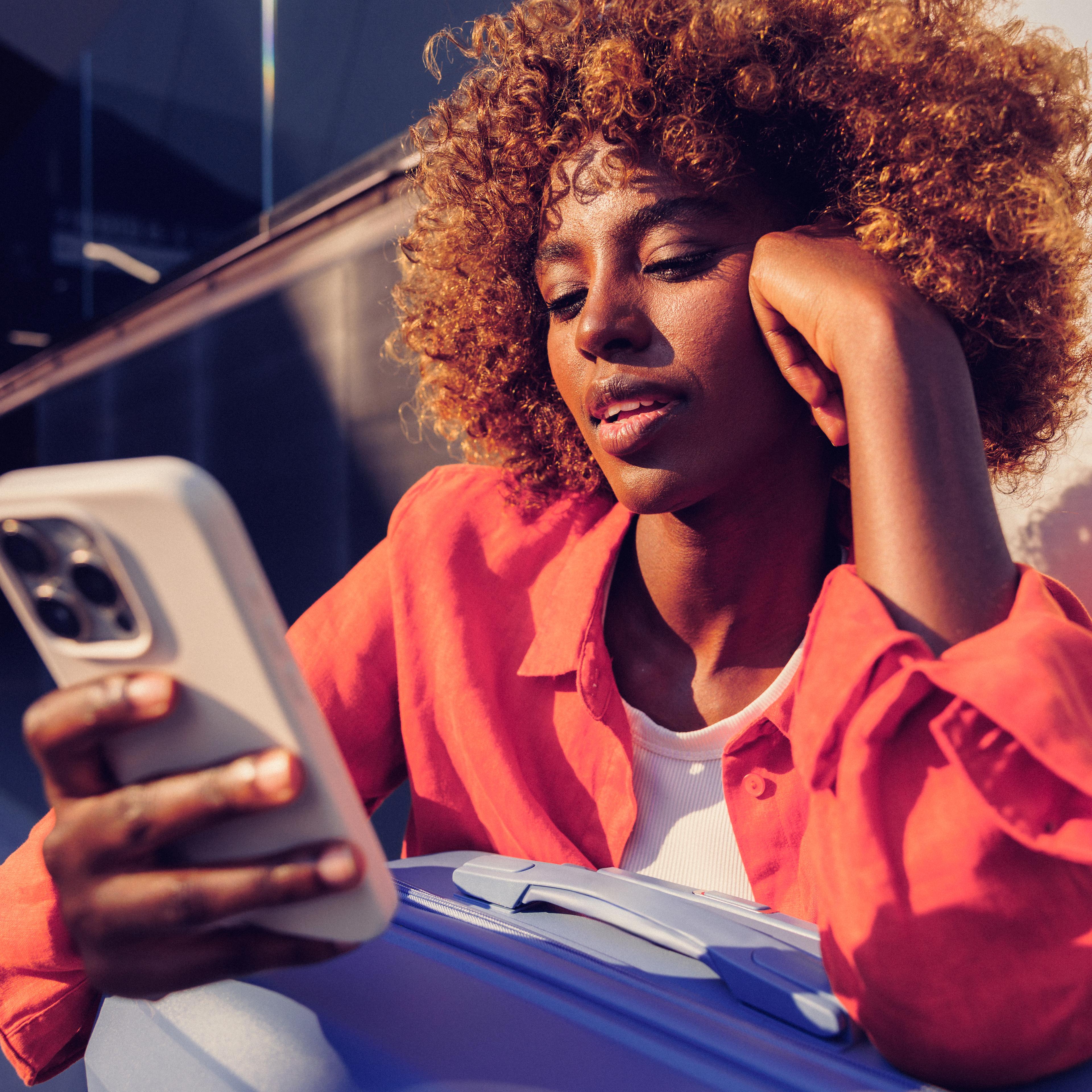 Woman resting her head on her hand as she reads her phone