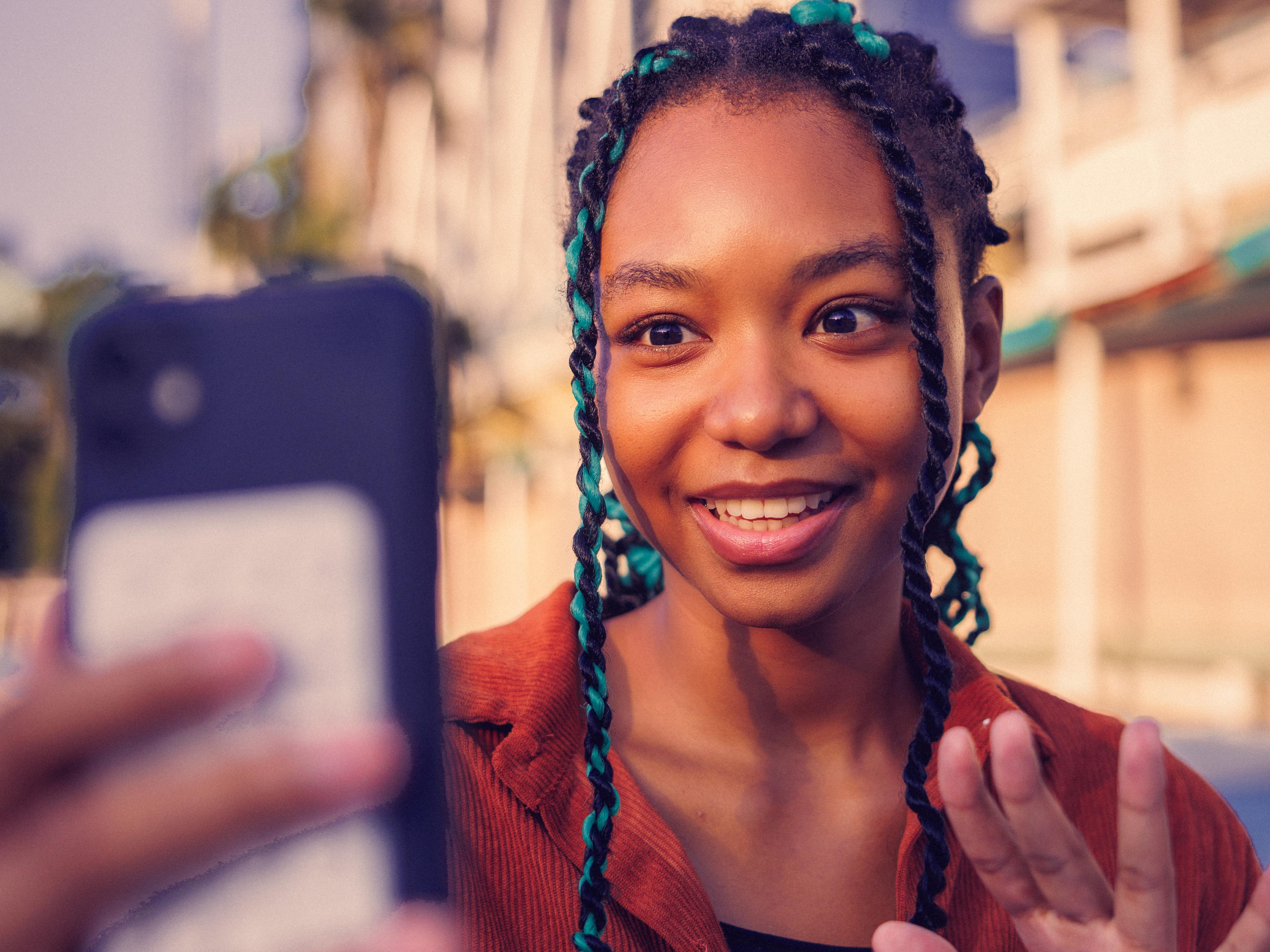 Woman speaking into a phone held close to her face
