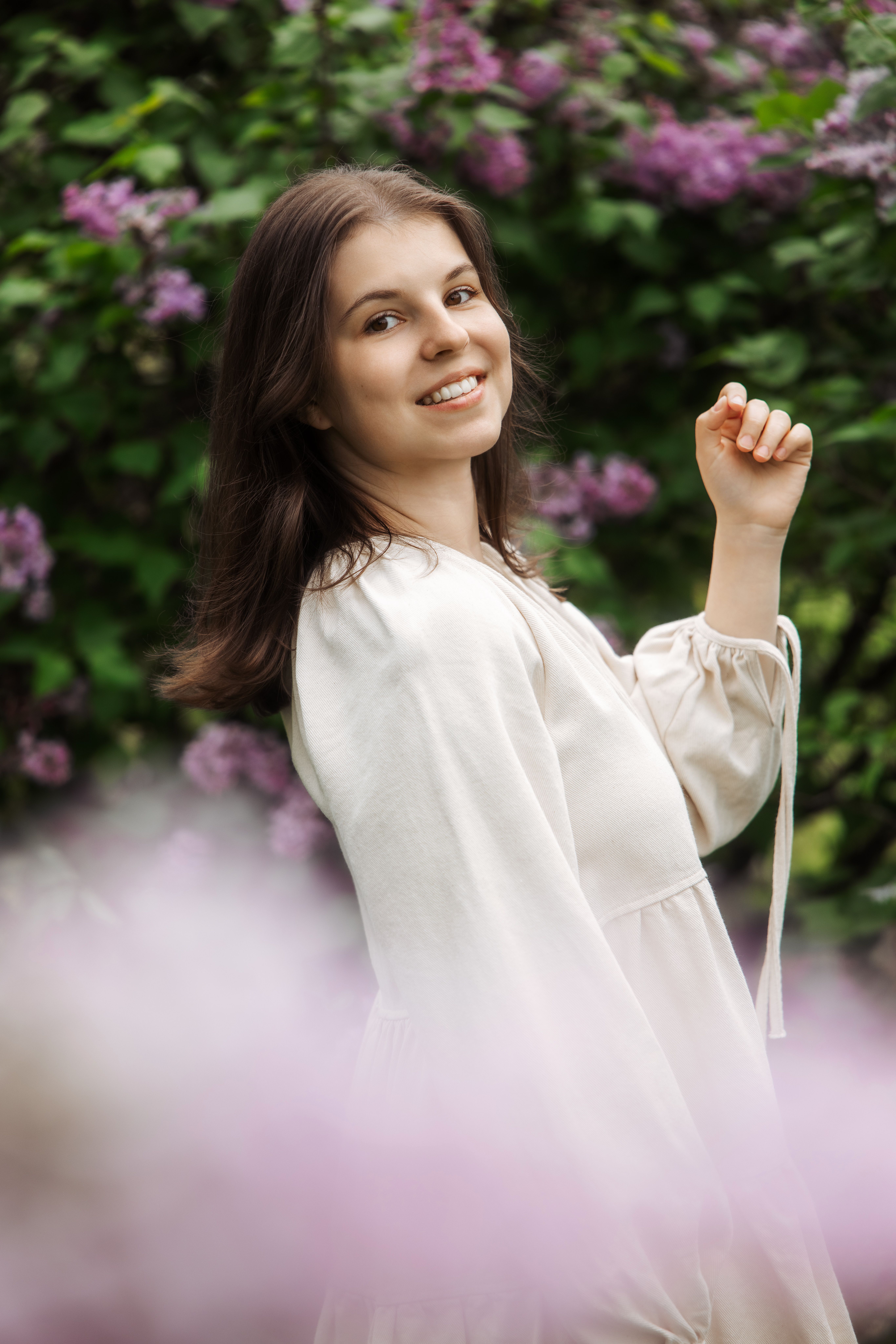 Anna standing beside a quiet woodland stream