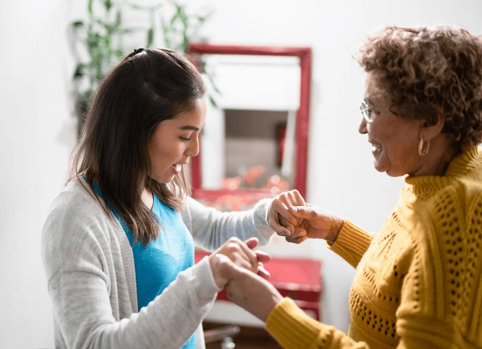 Carer helping out elderly woman with walking