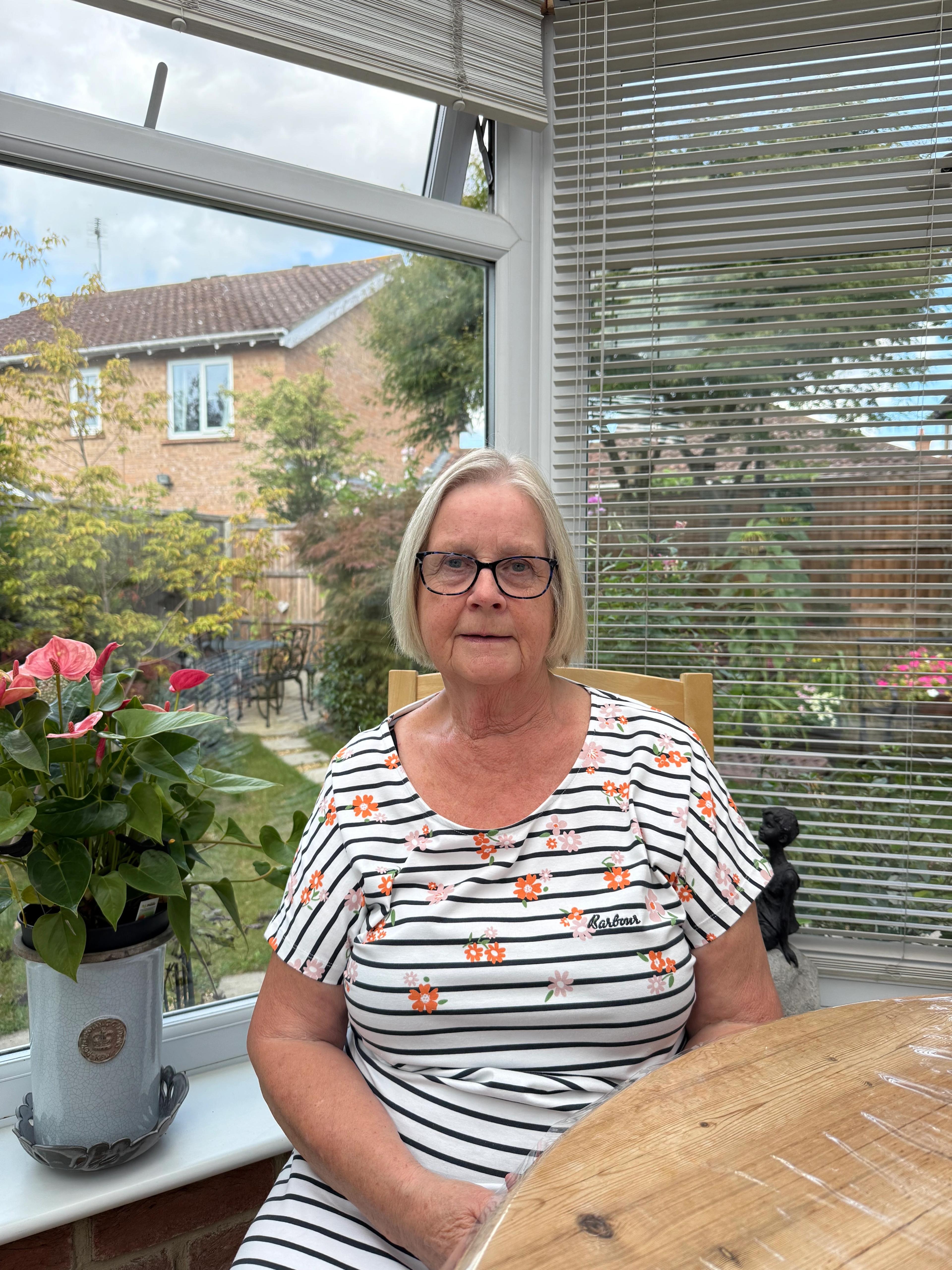 Anne sitting in her kitchen