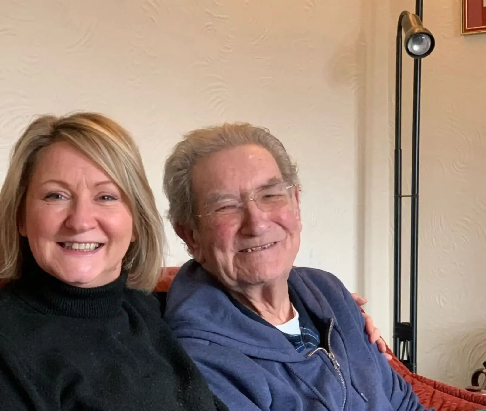 Hayley and her dad Colin sitting on the sofa