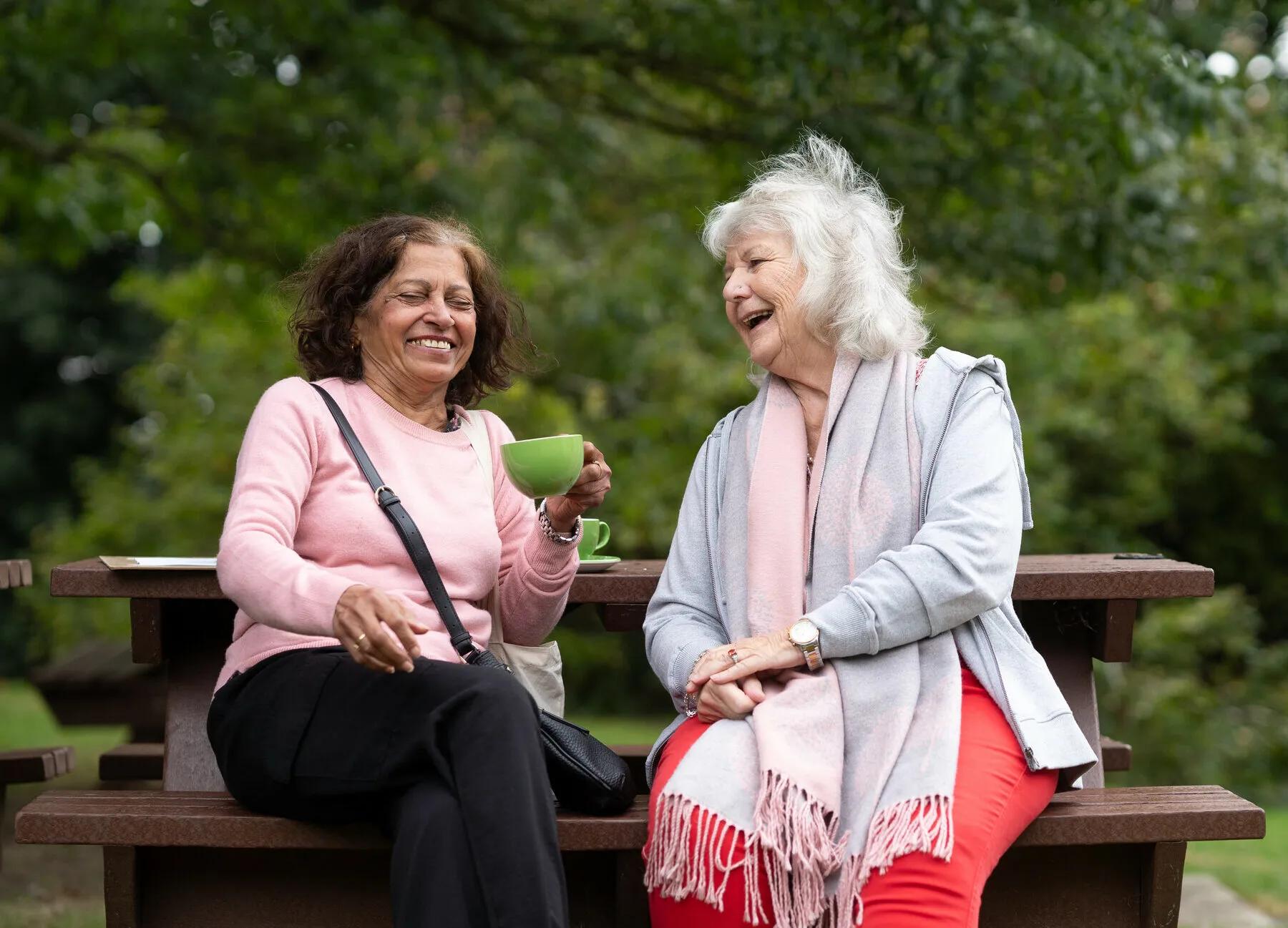 two elderly women drinking tea
