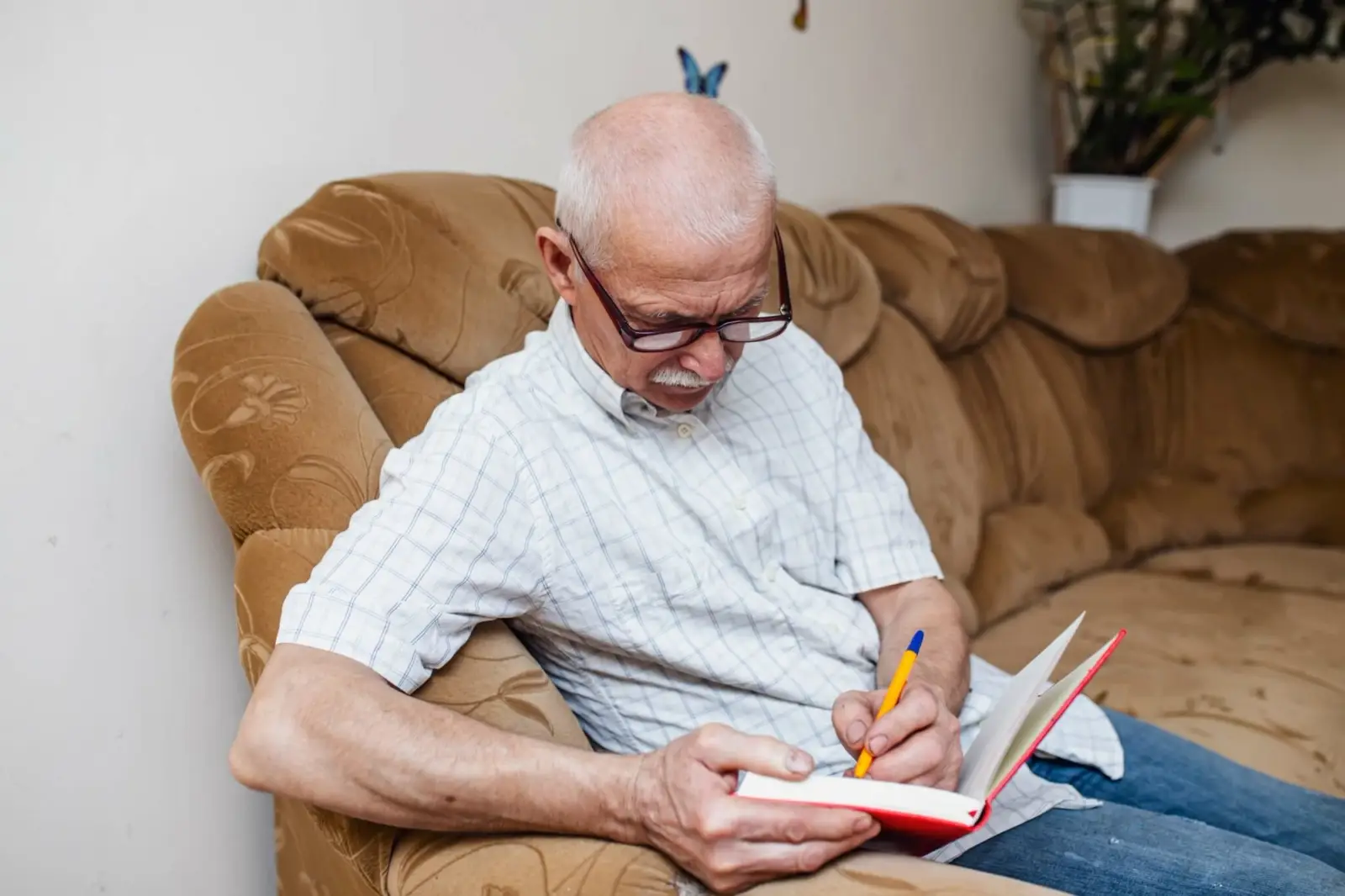 Elderly man taking notes in his notebook