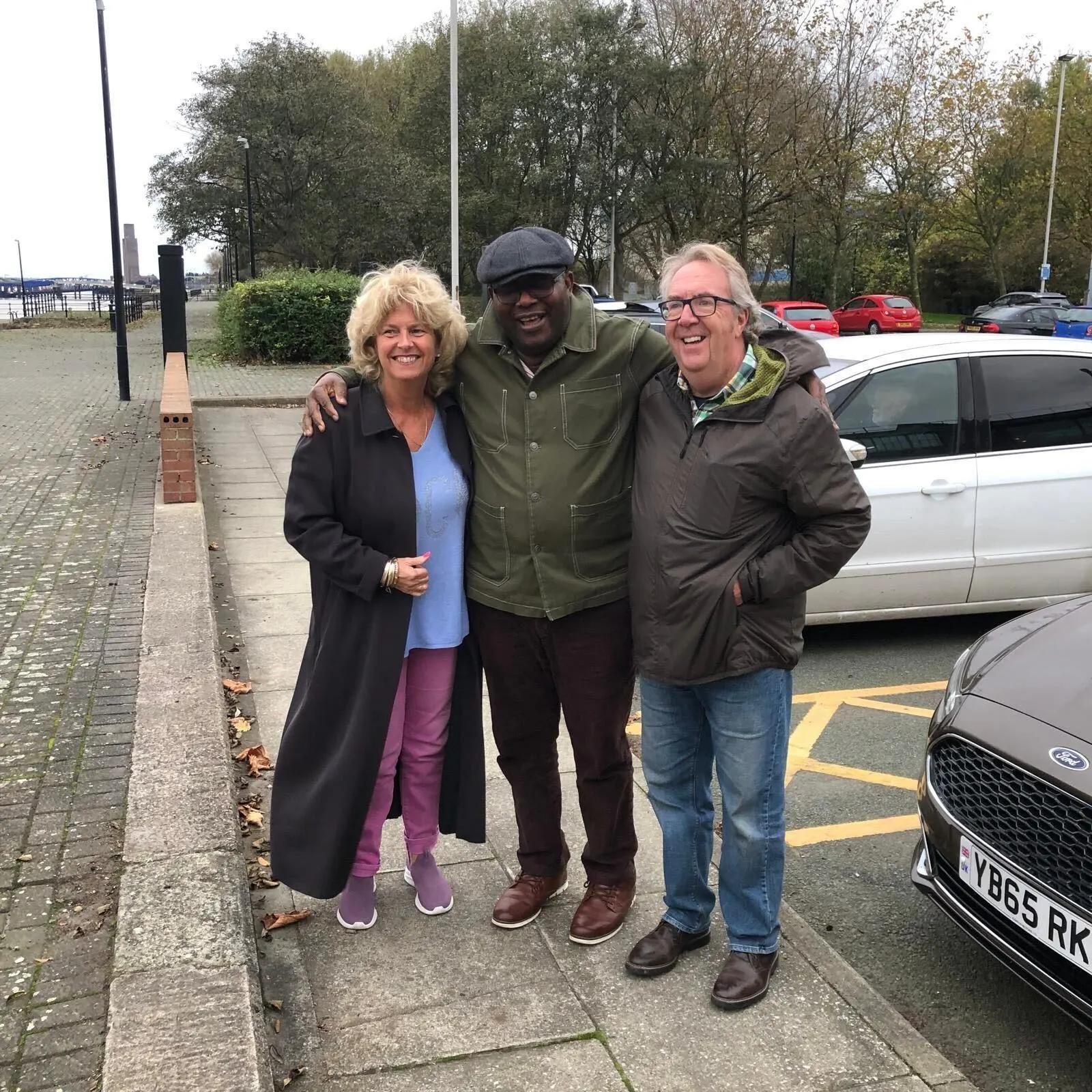 Mike with his wife Sue and his carer Godswill
