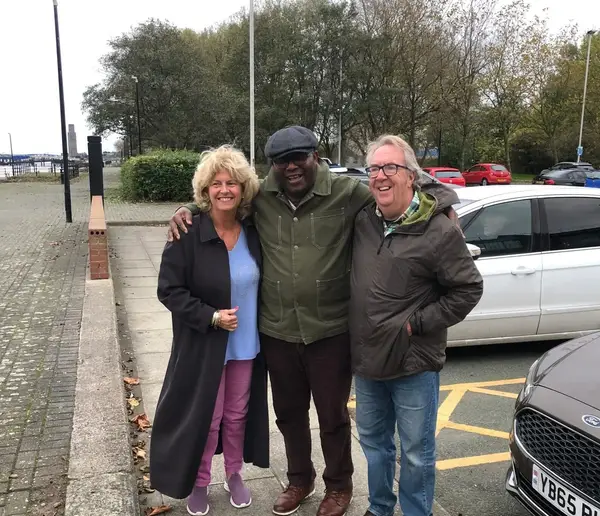 Mike and his wife Sue with their carer Godswill