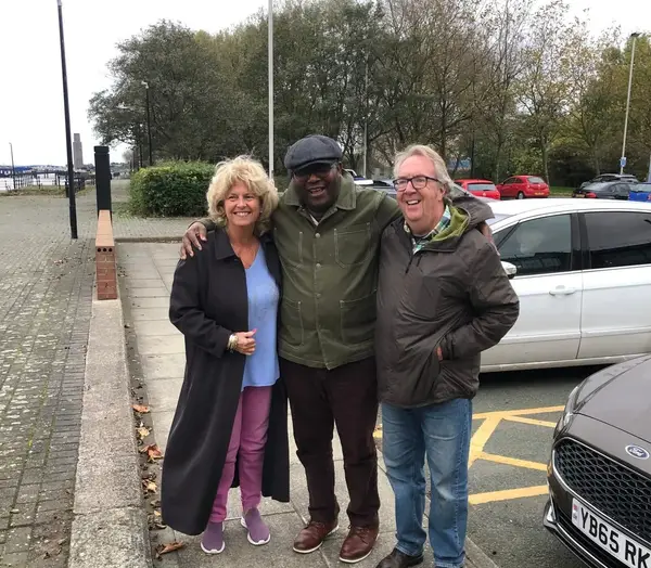 Mike with his wife Sue and his carer Godswill