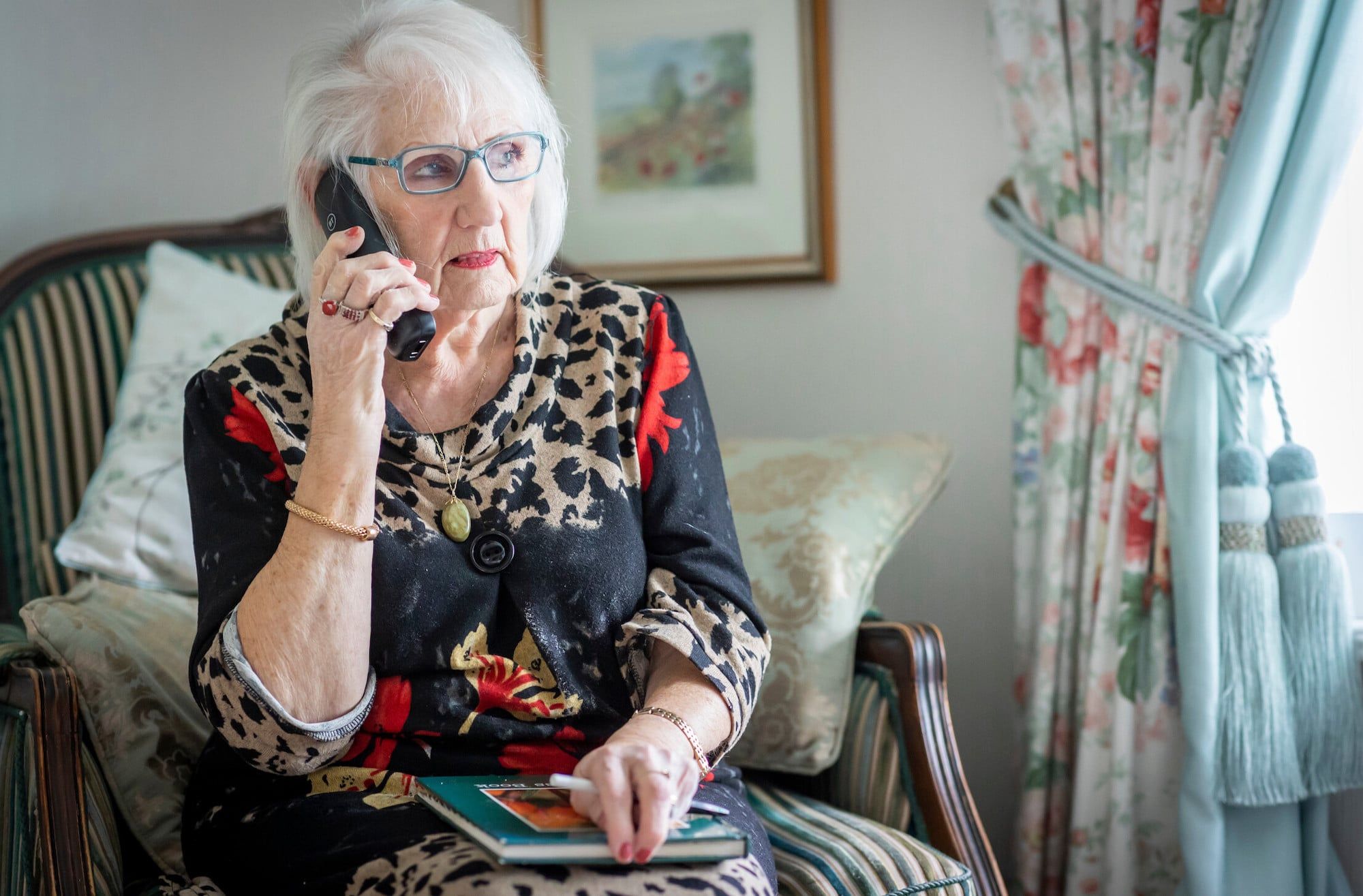 Woman sitting whilst on the phone