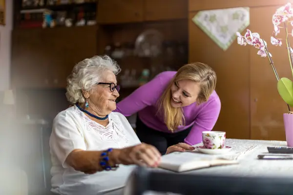 Elderly lady with carer