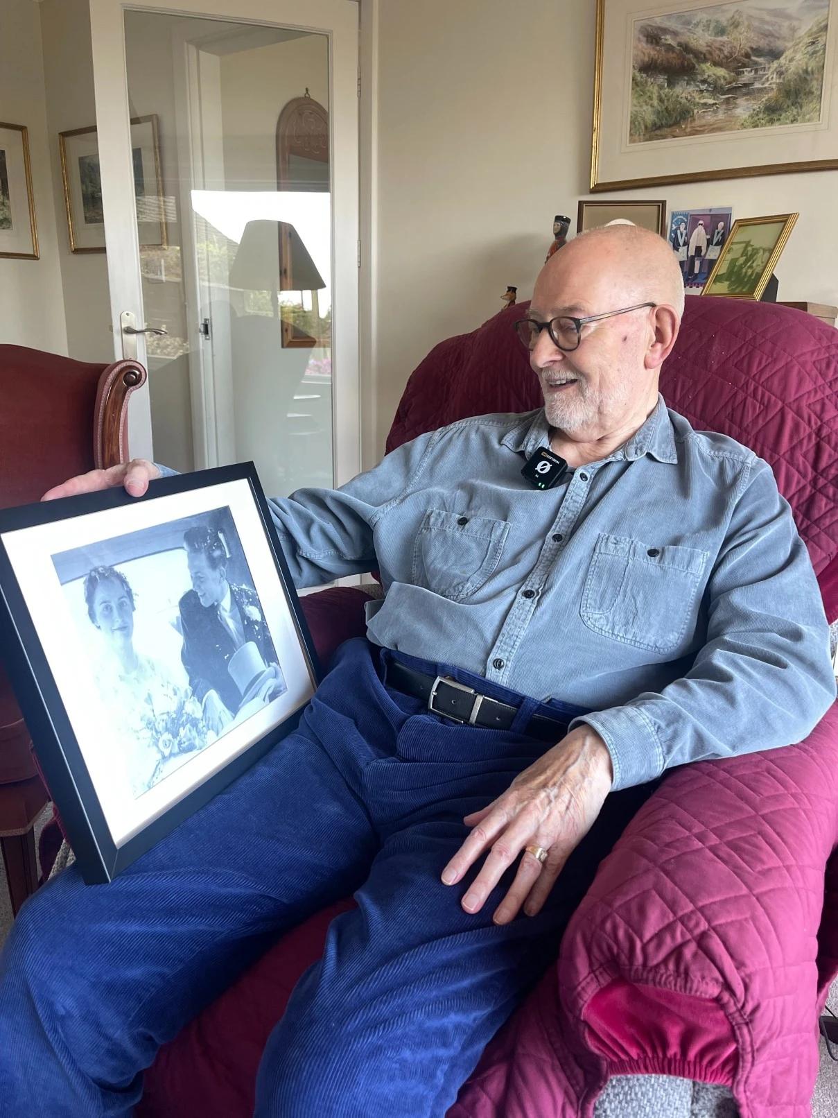 Mr Beard looking at his wedding photo