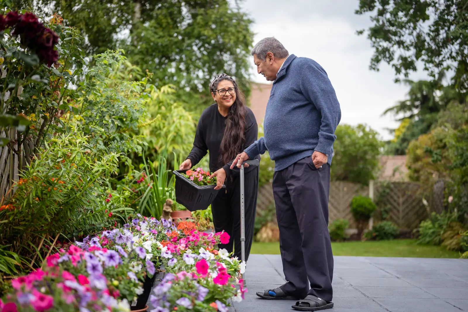Elderly man with his carer in the garden