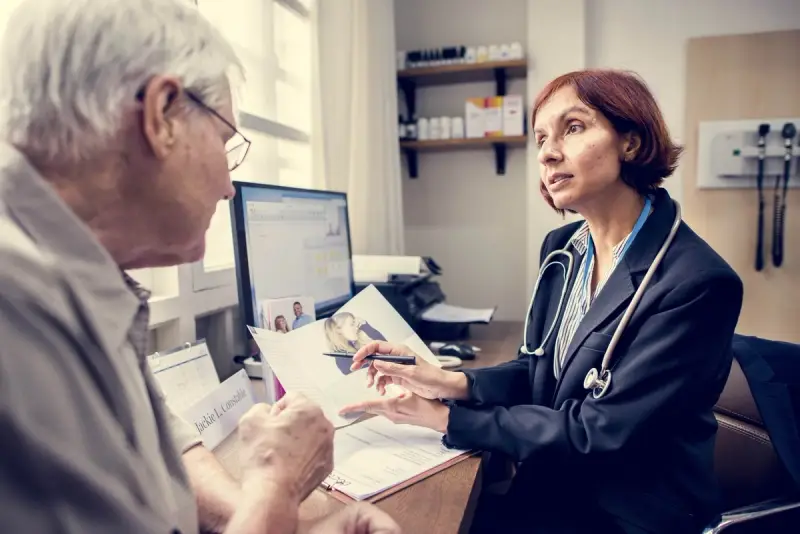 Doctor talks to elderly patient in a doctor's office