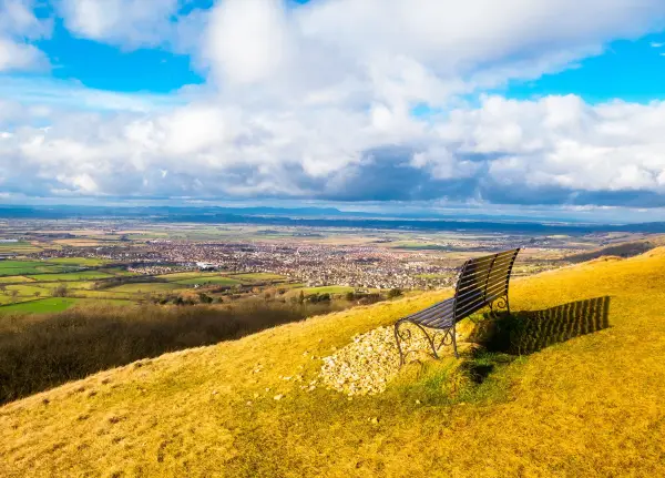 Bench on a hillside overlooking Cheltenham and the Cotswold countryside