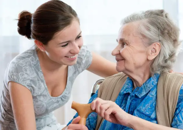 Smiling carer and elderly woman