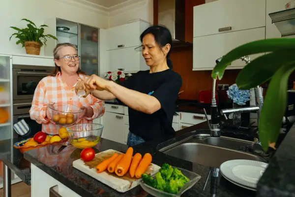 Two people cooking in a kitchen