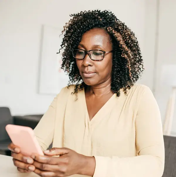 Woman with glasses reading on her phone