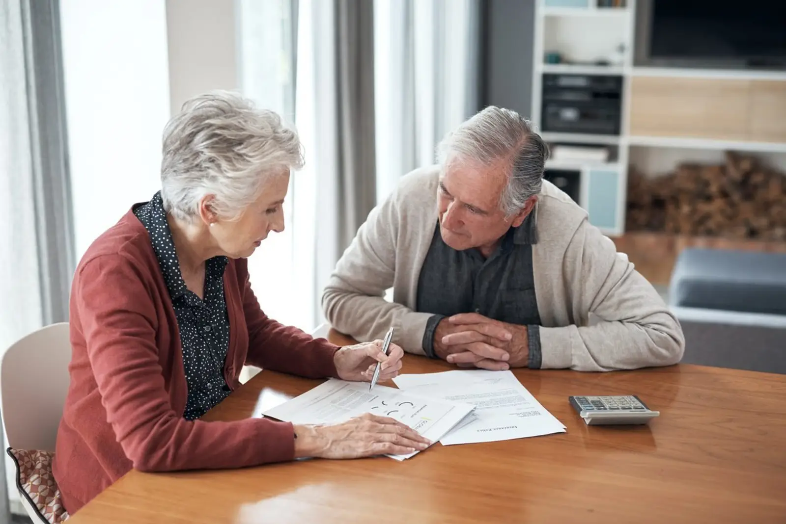 Elderly couple going through their finances at home