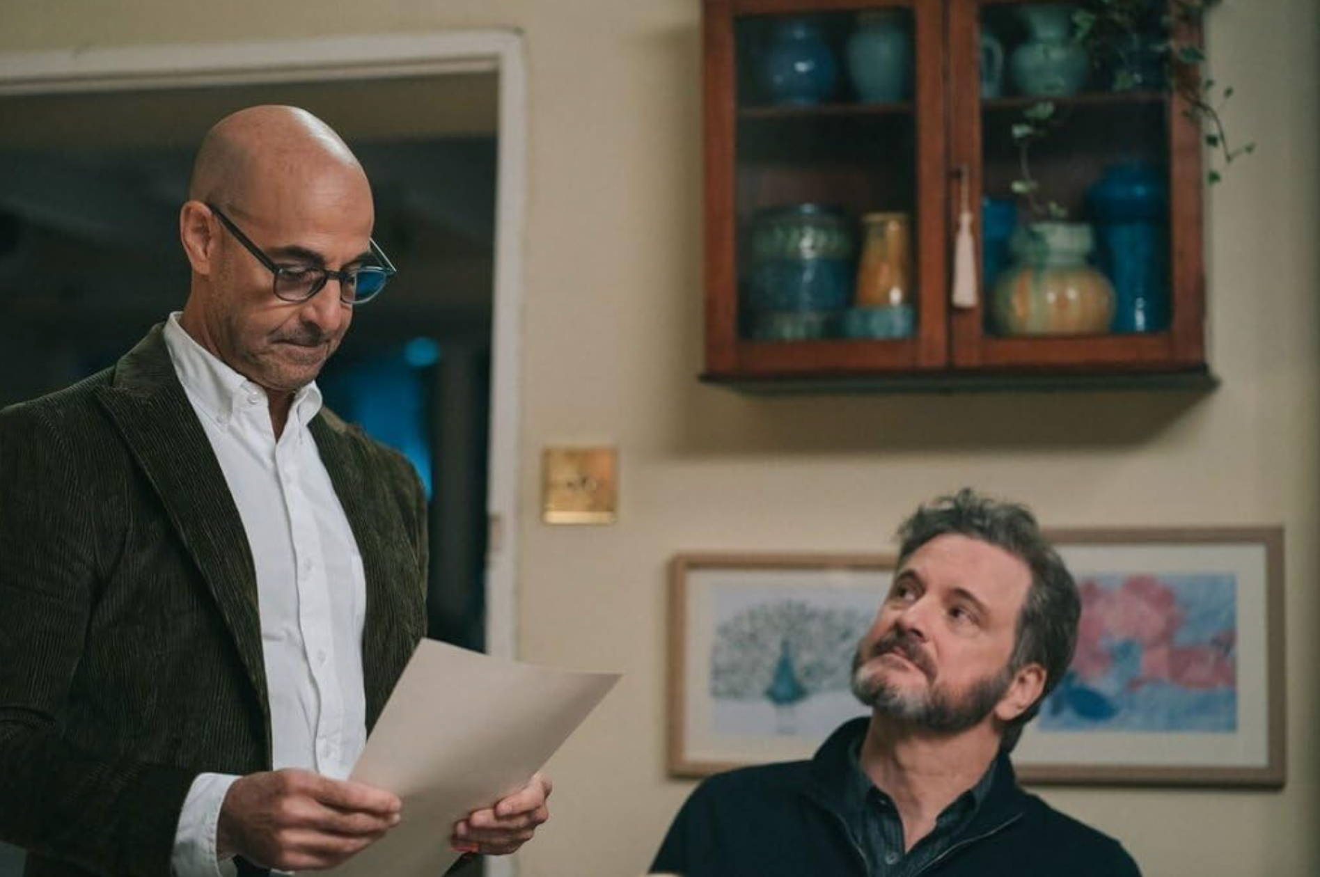 Tusker, living with young onset dementia, reads a letter as his partner Sam looks on in Supernova (2020)