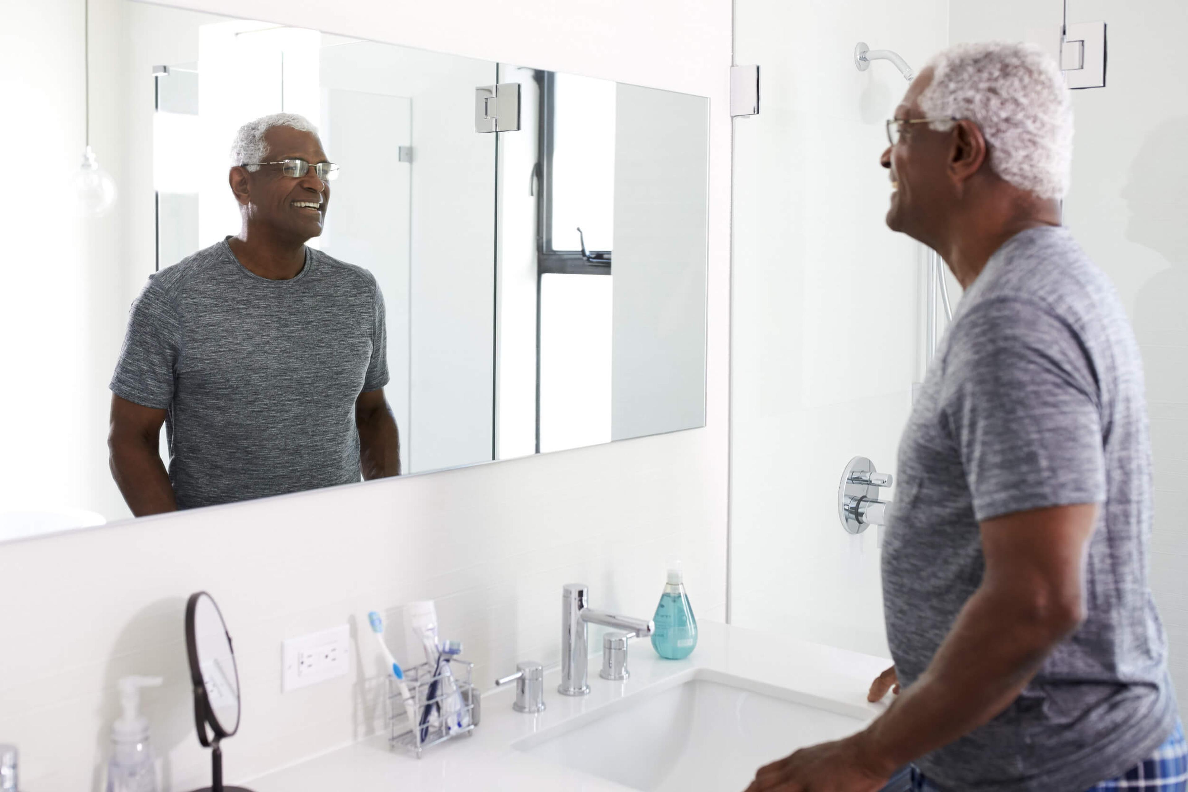 Elderly man looking at mirror