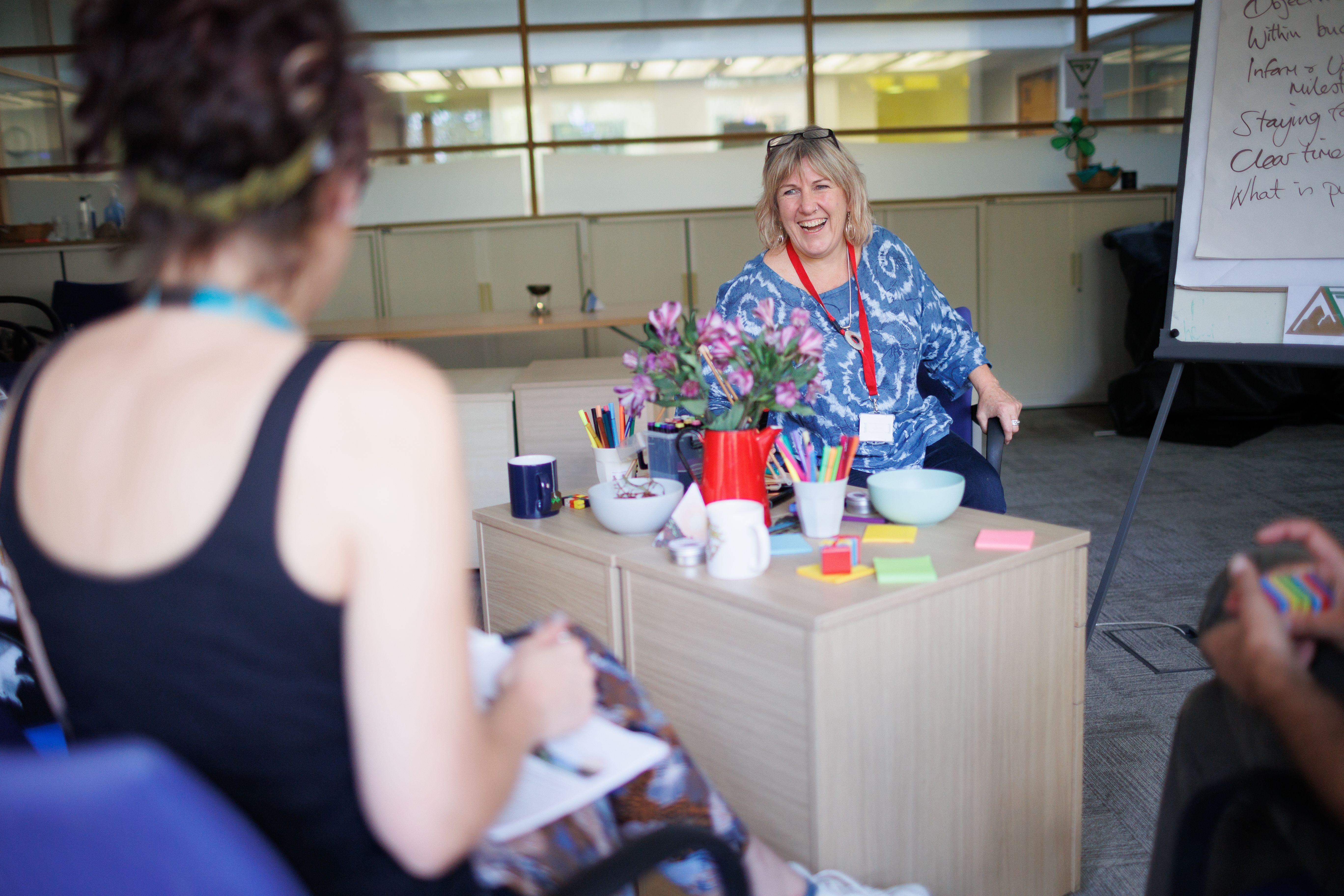 A woman taking notes in a session