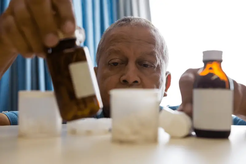 Older man taking his medication