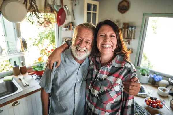 Father adn daughter in the kitchen smiling