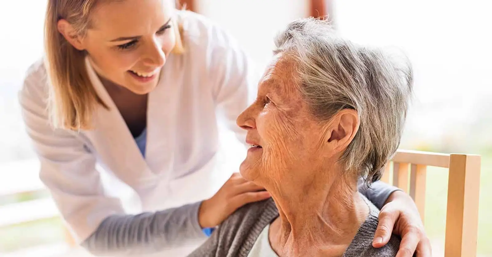 Elderly woman with her carer