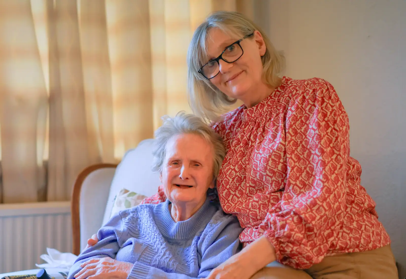 A happy gran drinking tea with carer