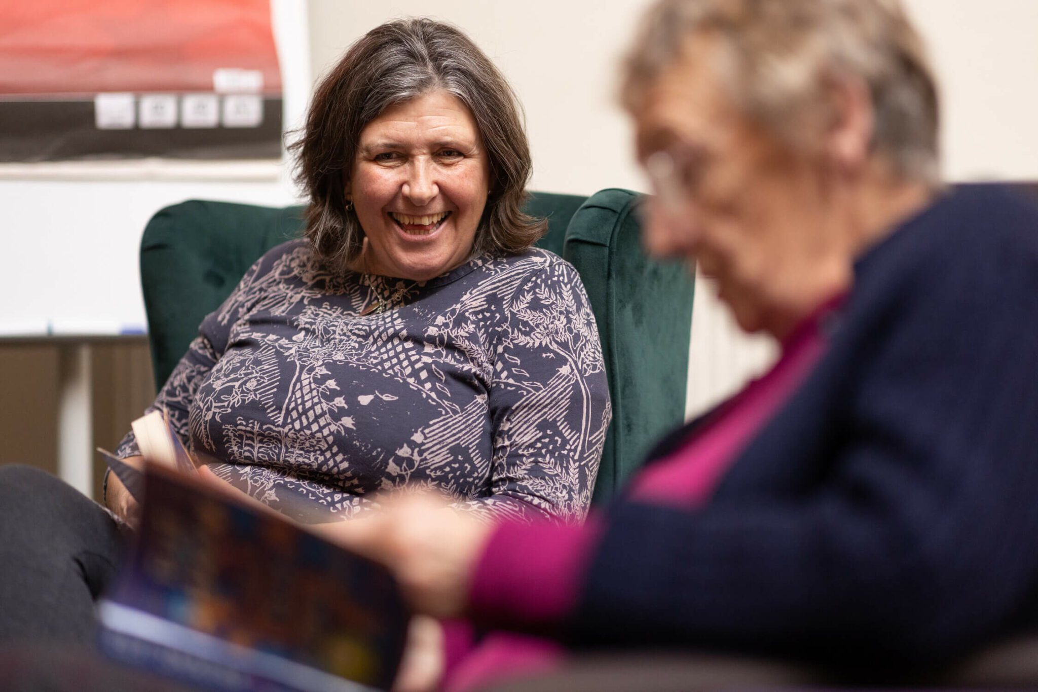 Two elderly women reading books