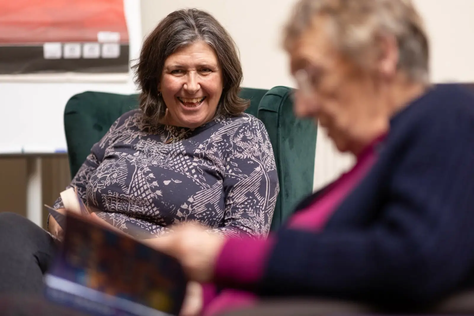 Two elderly women reading books