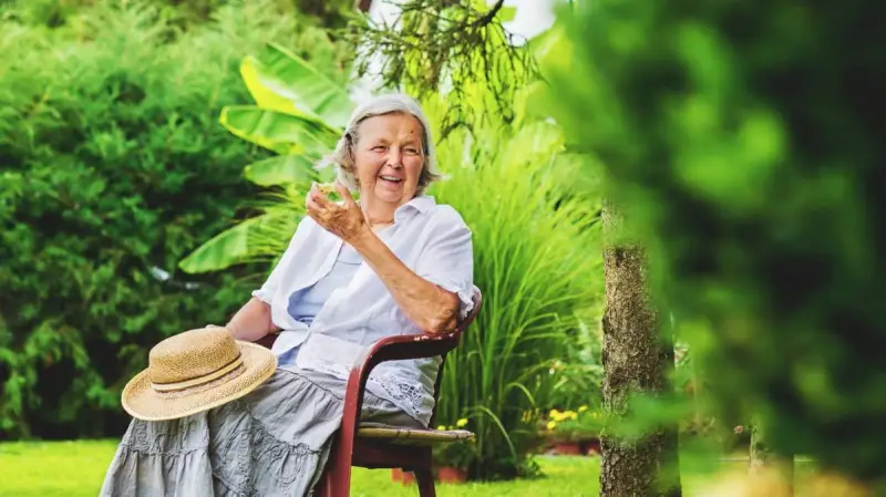 Elderly woman sitting in a garden