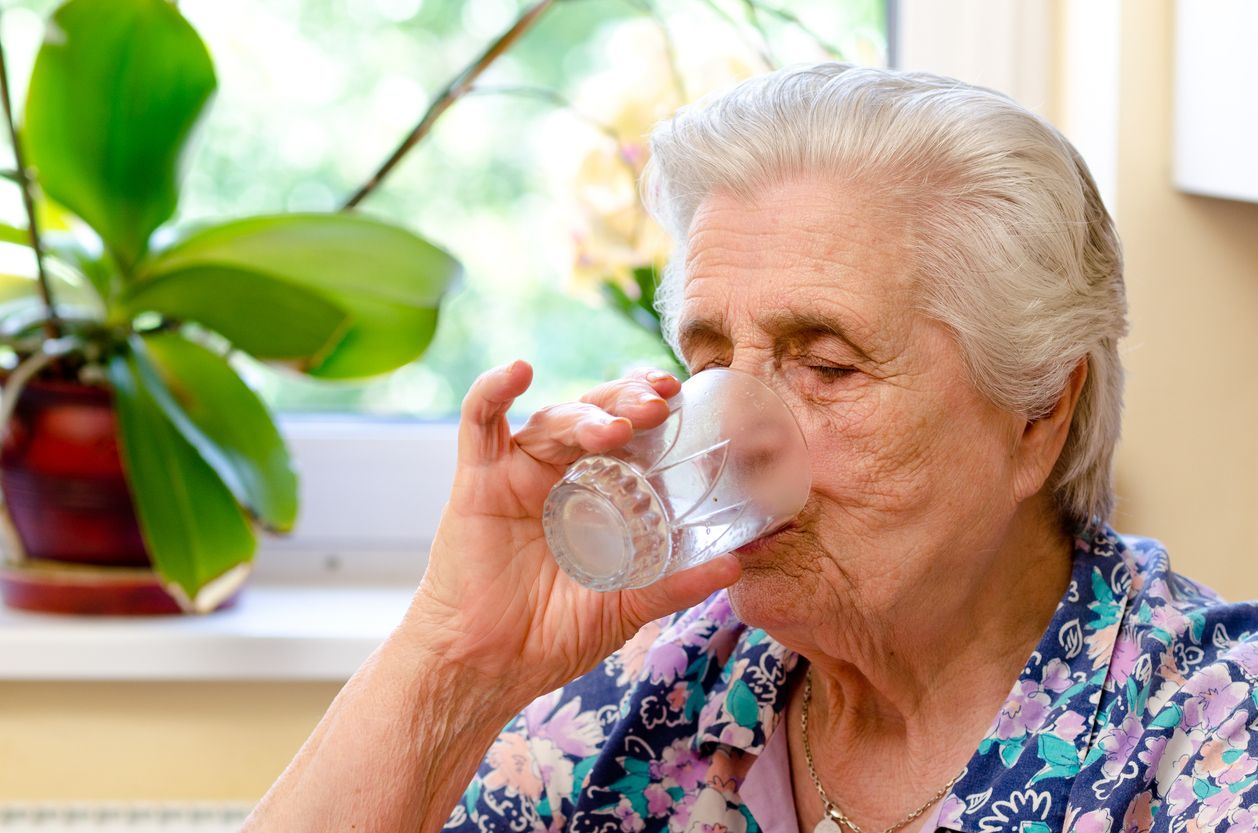 Elderly woman drinking water 